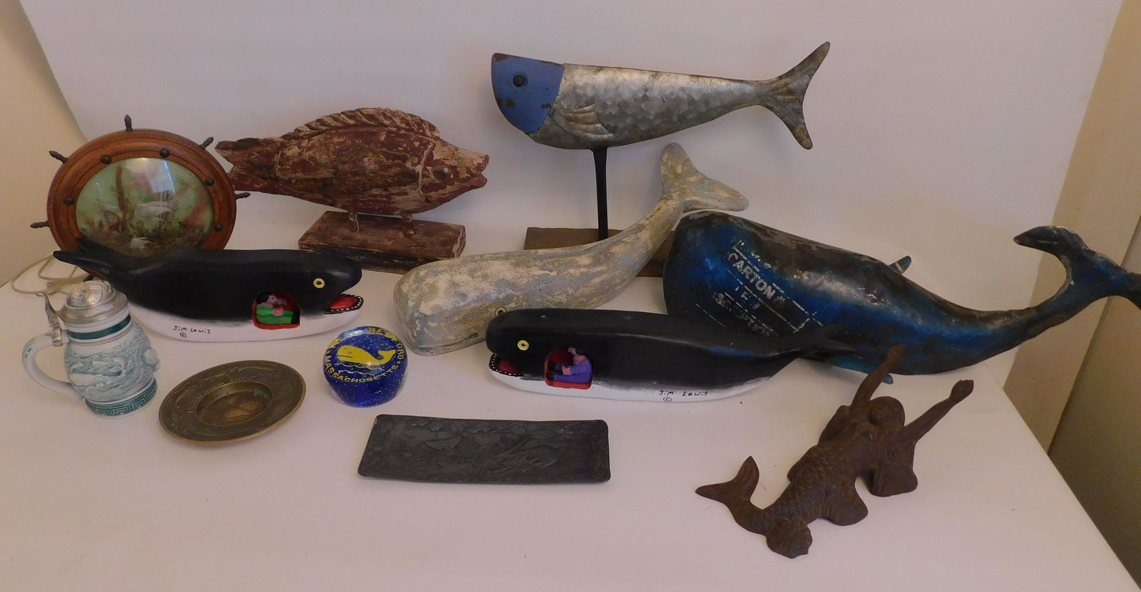 LOT MARITIME RELATED ITEMS ETC: Lot of mostly maritime related items including 2 signed Jim Lewis "Jonah & The Whale" wood carvings; Metal fish on stand; electric lamp with ship wheel and fish; New Bedford paperweight; Small Avon st