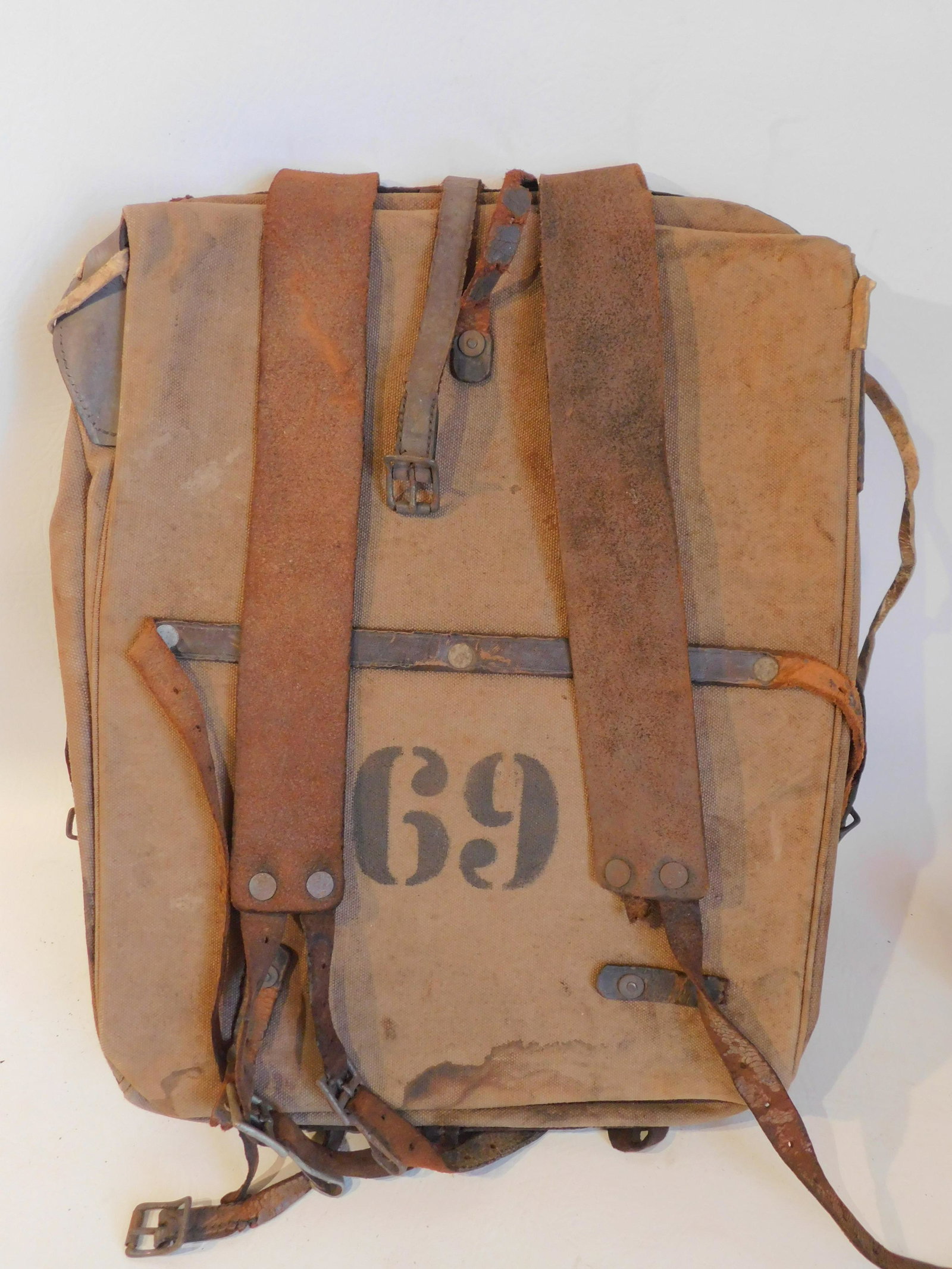 SPANISH AMERICAN WAR BACKPACK: Dated 1898 Spanish American War backpack or haversack with stenciled CO. F 69. Leather and burlap, 17 x 12 inches. Good condition overall