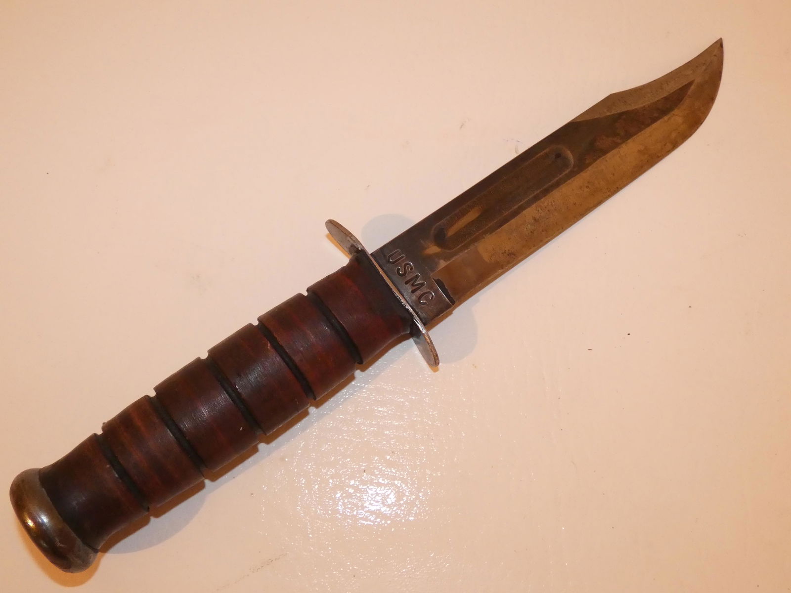WWII KABAR KNIVE: WWII Marine Kabar fighting knife with wood handle, stamped USMC, Olean NY. 12 in long.