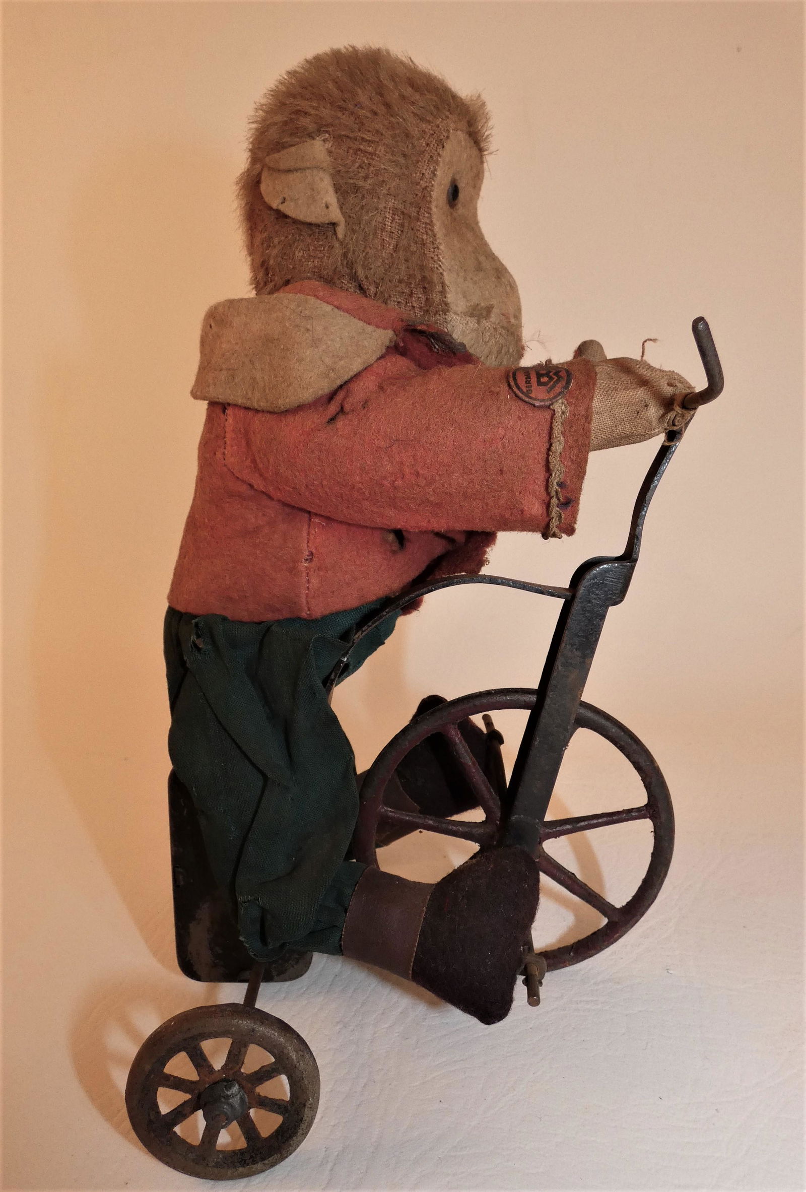 BING BROS MONKEY ON BIKE TOY: Circa 1920 monkey on tricycle windup toy with original Bing Bros. label. 9 in tall, working.