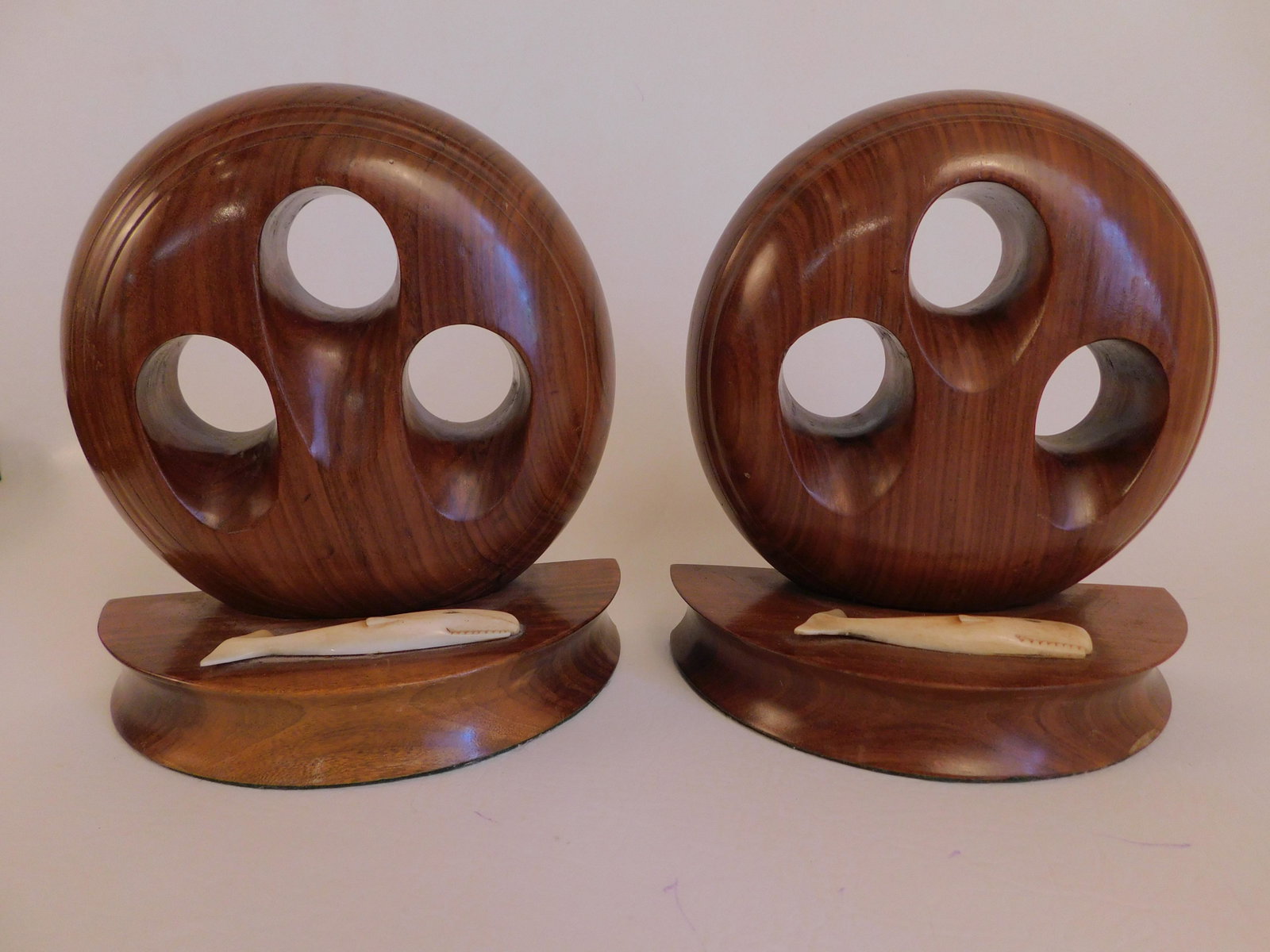 ROSEWOOD & WHALE BONE BOOKENDS: Pair of fine quality rosewood deadeye-form nautical bookends with carved bone whale plaques. 8 in tall.