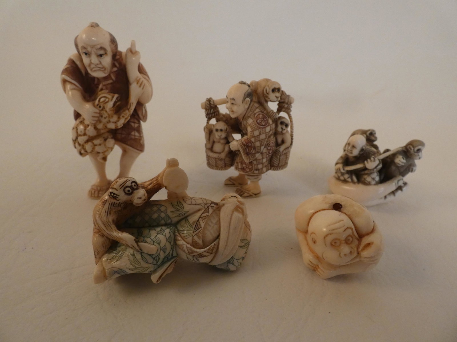 5 JAPANESE NETSUKES - MONKEYS: Lot 5 old Japanese carved bone netsukes to 2.5 in tall depicting men with monkeys. Two are signed.