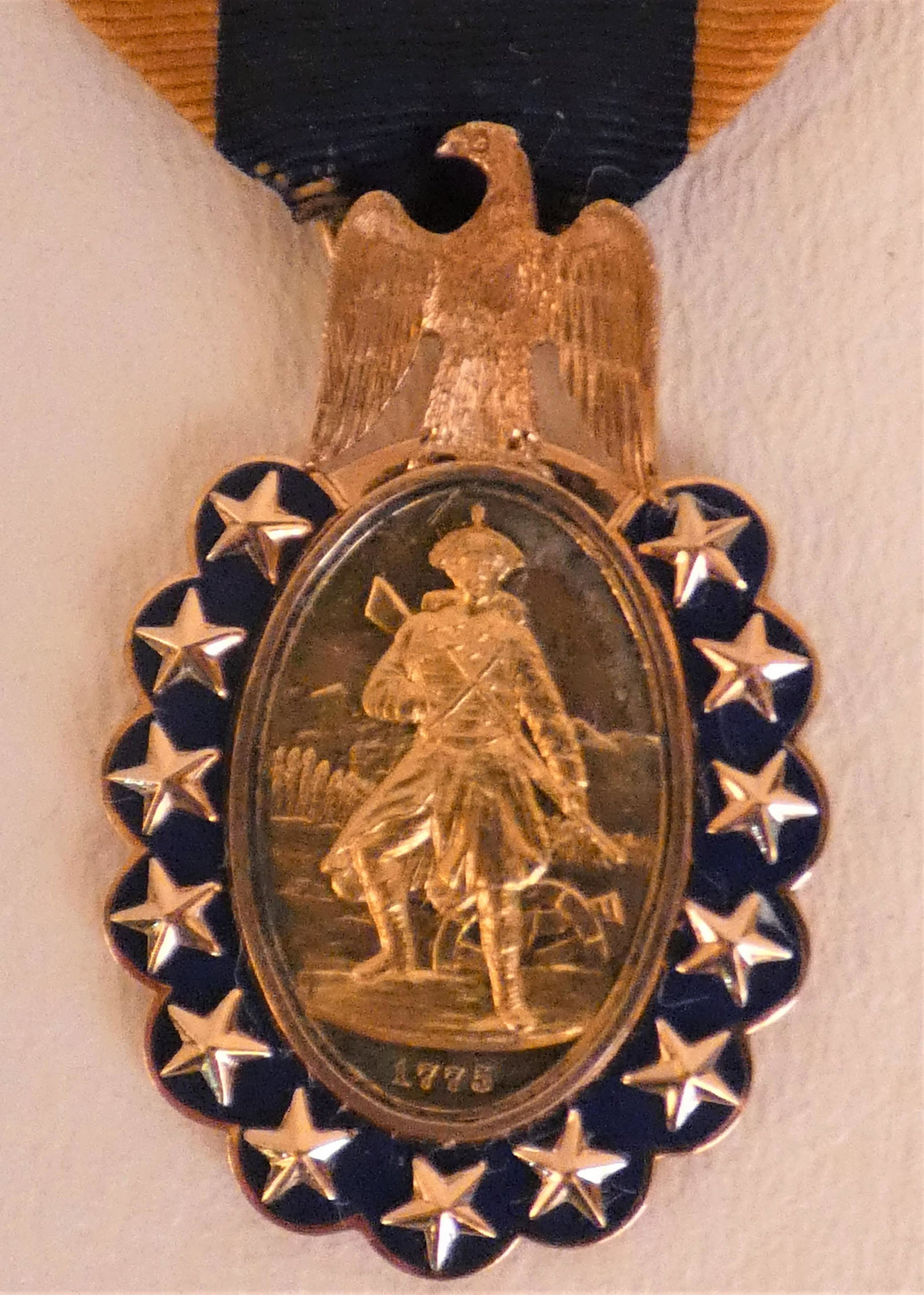 SONS OF AMERICAN REVOLUTION GOLD MEDAL: 14K gold SONS OF THE REVOLUTION enameled medal dated 1883 with a Minuteman on front and Washington on back. Has engraved member no. 793. Size: 1.62 in long medal (with original ribbon 3 in long). Fine