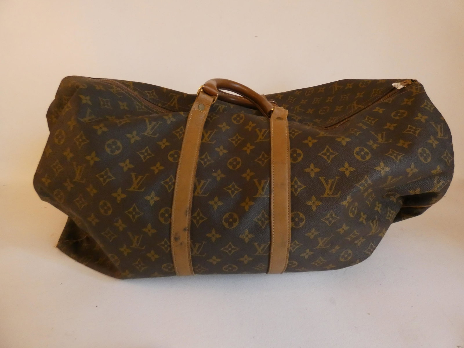 LOUIS VUITTON LUGGAGE: Vintage Louis Vuitton LV logo duffel bag with leather trim. 24 x 12 in approx. Light wear.