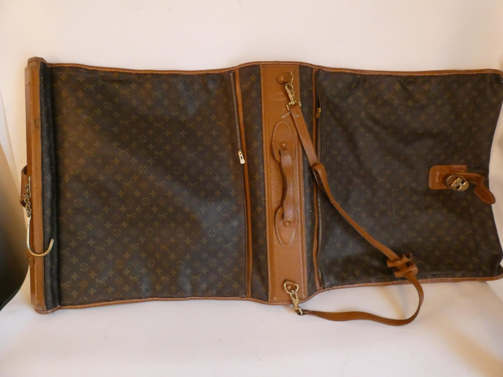 LOUIS VUITTON LUGGAGE: Vintage Louis Vuitton LV logo garment bag with tan leather trim. 50 x 23 inches approx. Light wear