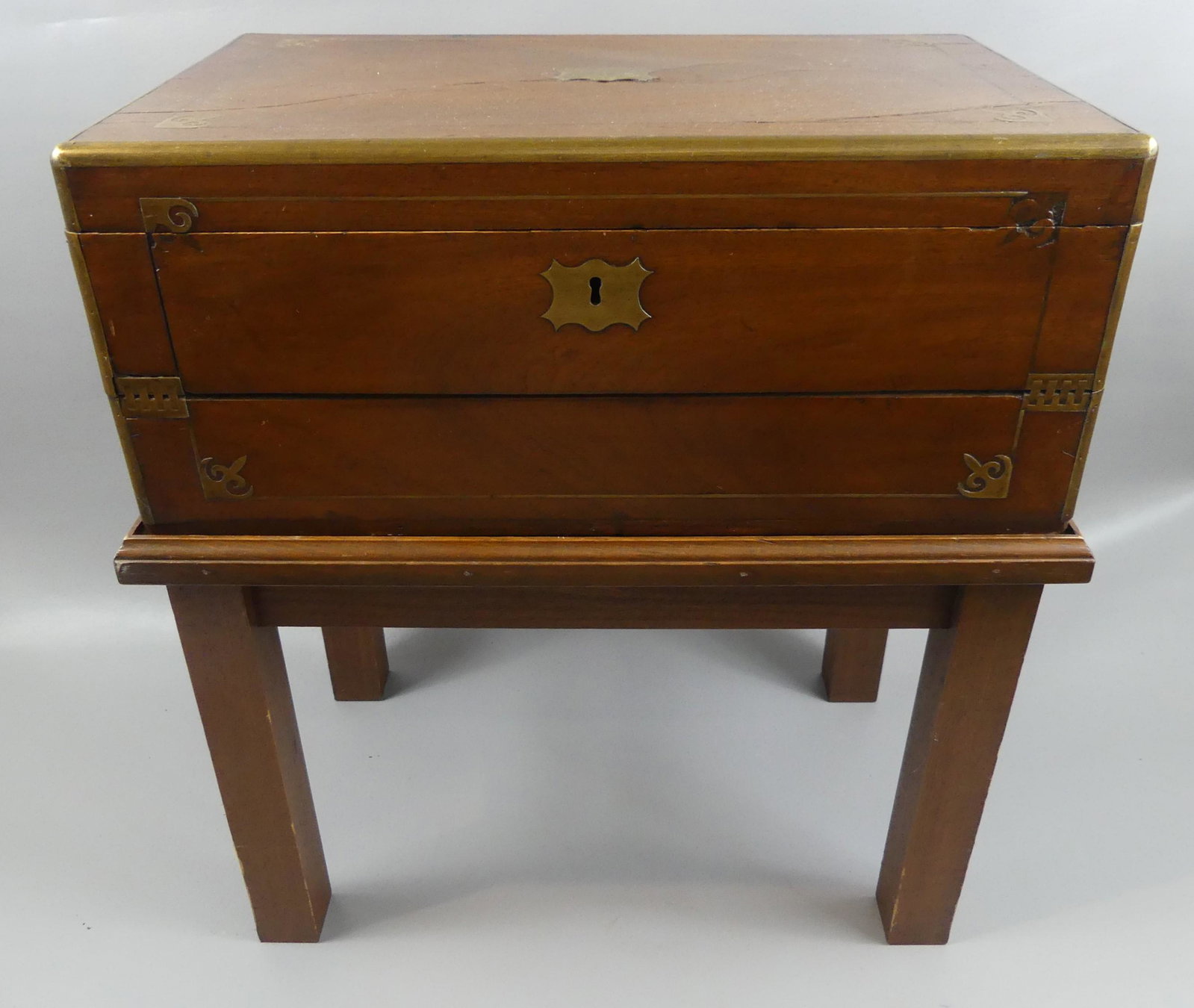 ANTIQUE CAMPHORWOOD DESK ON STAND: Circa 1850 camphorwood brass-bound lap desk with fitted compartments and writing surface, mounted on later wood stand. Box is 20 x 12 x 8 in high, overall 22 inches high. Comes with 1908 Fall River re