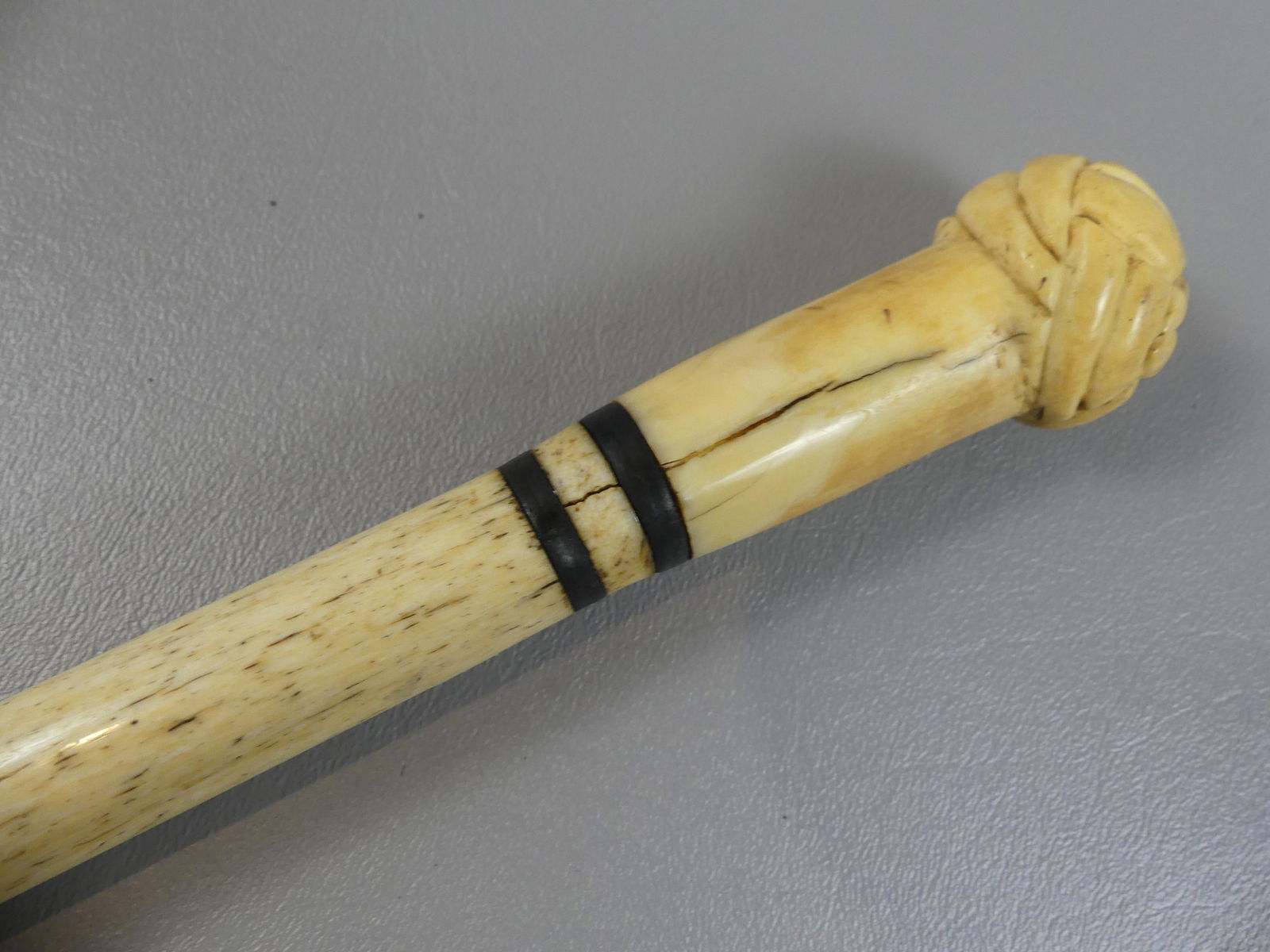 TURKS HEAD KNOT WHALE BONE CANE: 19th century sailor made whale bone cane with Turks head knob handle and baleen rings. 1.25" diam. 33.5 in long.