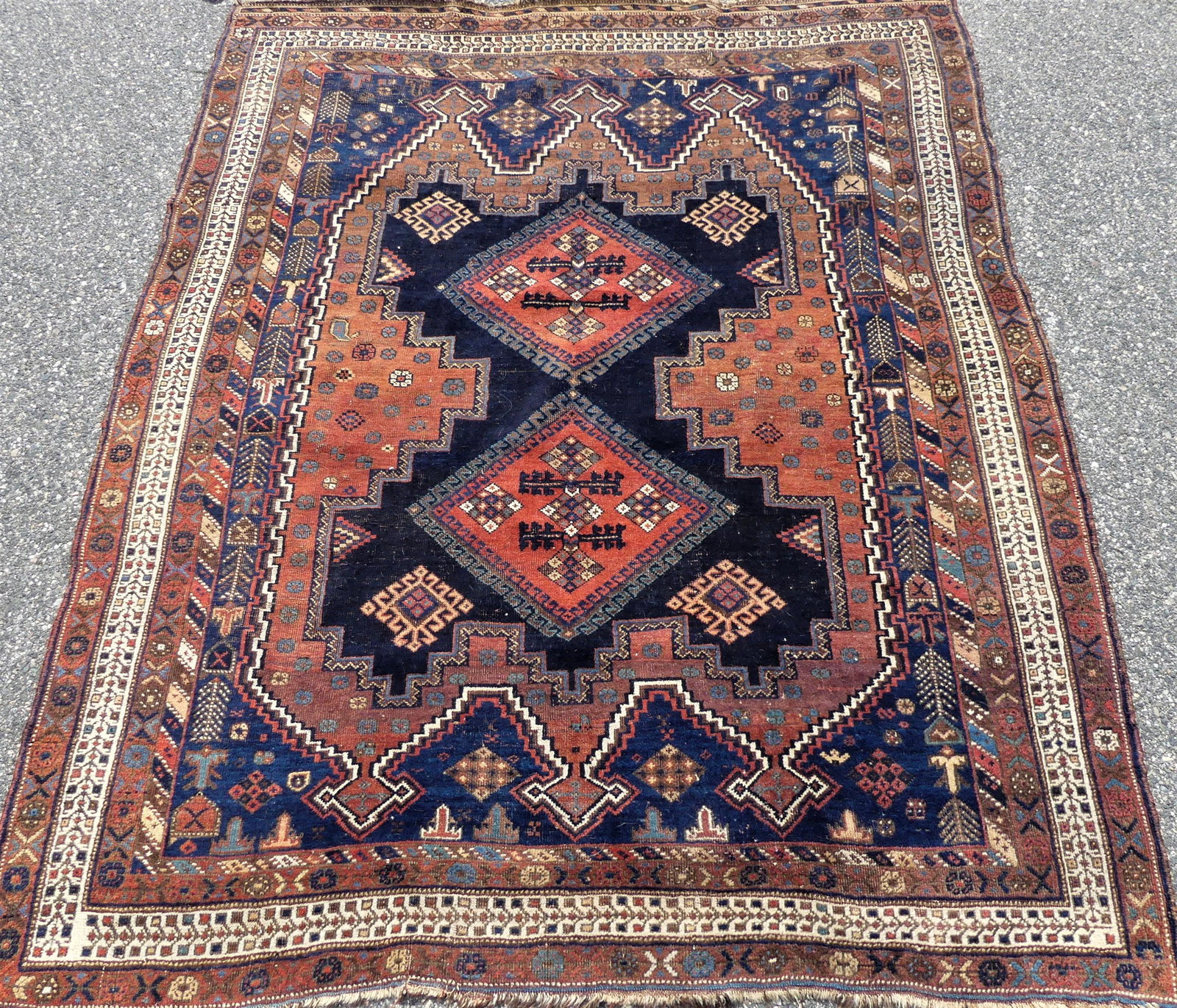 ANTIQUE SHIRAZ 5 X 6 FOOT RUG: Antique Shiraz scatter rug in navy blue and rust colors with 2 medallions, good condition, almost square at 6 ft 2 inches by 5 ft.