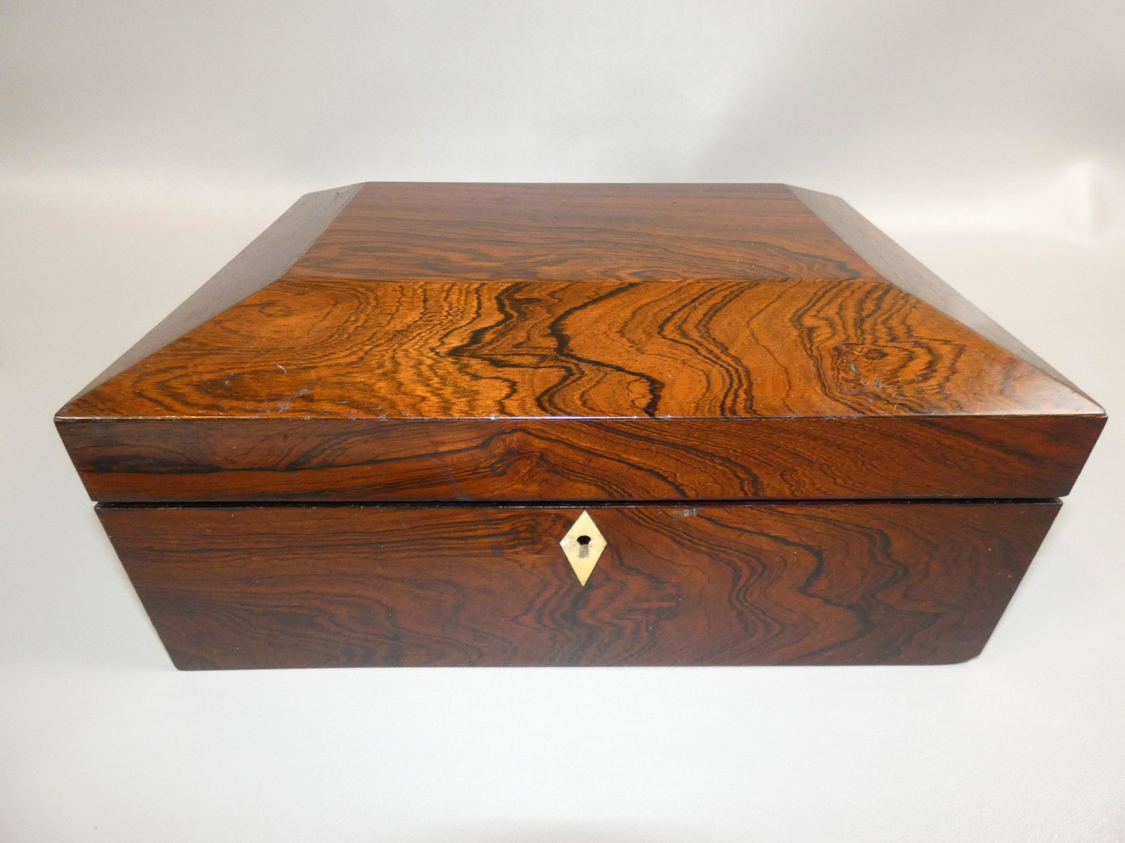 ANTIQUE ROSEWOOD SEWING BOX: Mid 19th century rosewood canted sewing box with birdseye maple interior and fitted drawer. 12 x 9 x 5.5 inches.
