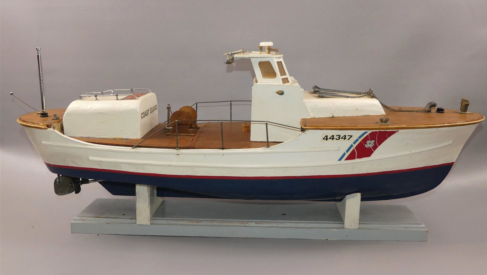 ELECTRIC COAST GUARD BOAT: Old wood painted Coast Guard boat with electric motor and batteries. Untested. 33 x 13 x 9 inches.