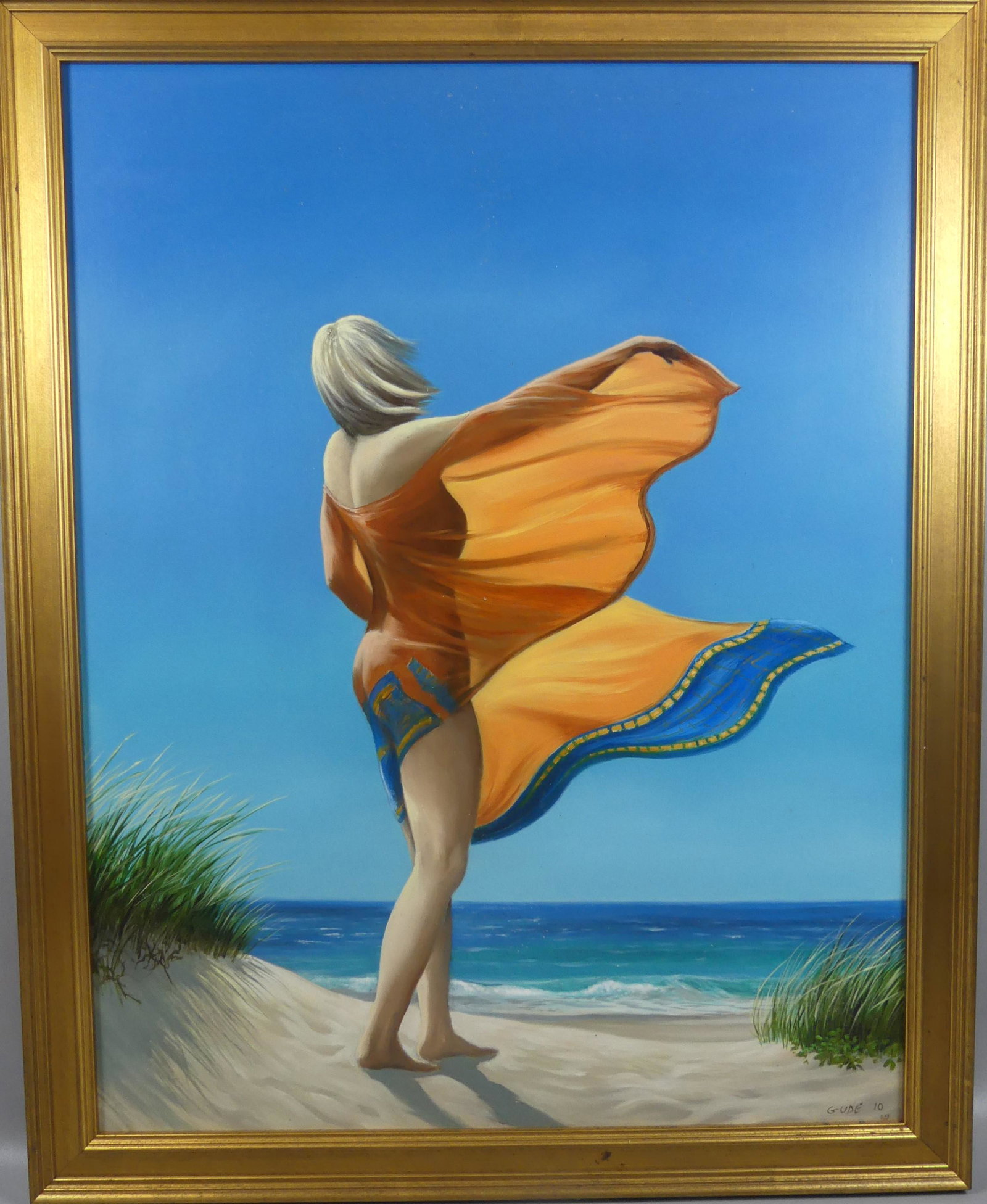 ANTHONY BENTON GUDE - BEACH PAINTING: Oil painting on masonite depicting a woman standing on beach with sarong blowing in the wind signed GUDE '10. Titled verso SURFSIDE BREEZE. Size: 32 x 25 inches, framed 36 x 29. (Anthony Benton Gude i