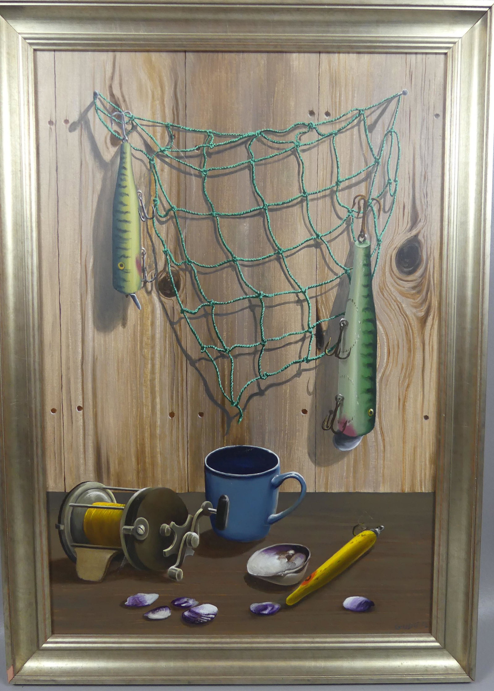 ANTHONY BENTON GUDE TROMPE L'OEIL PAINTING: Oil painting on masonite of a trompe l'oeil still life of fishing-related objects, coffee mug, and seashells signed GUDE '12. Size: 24 x 16 inches, framed 27 x 19.
