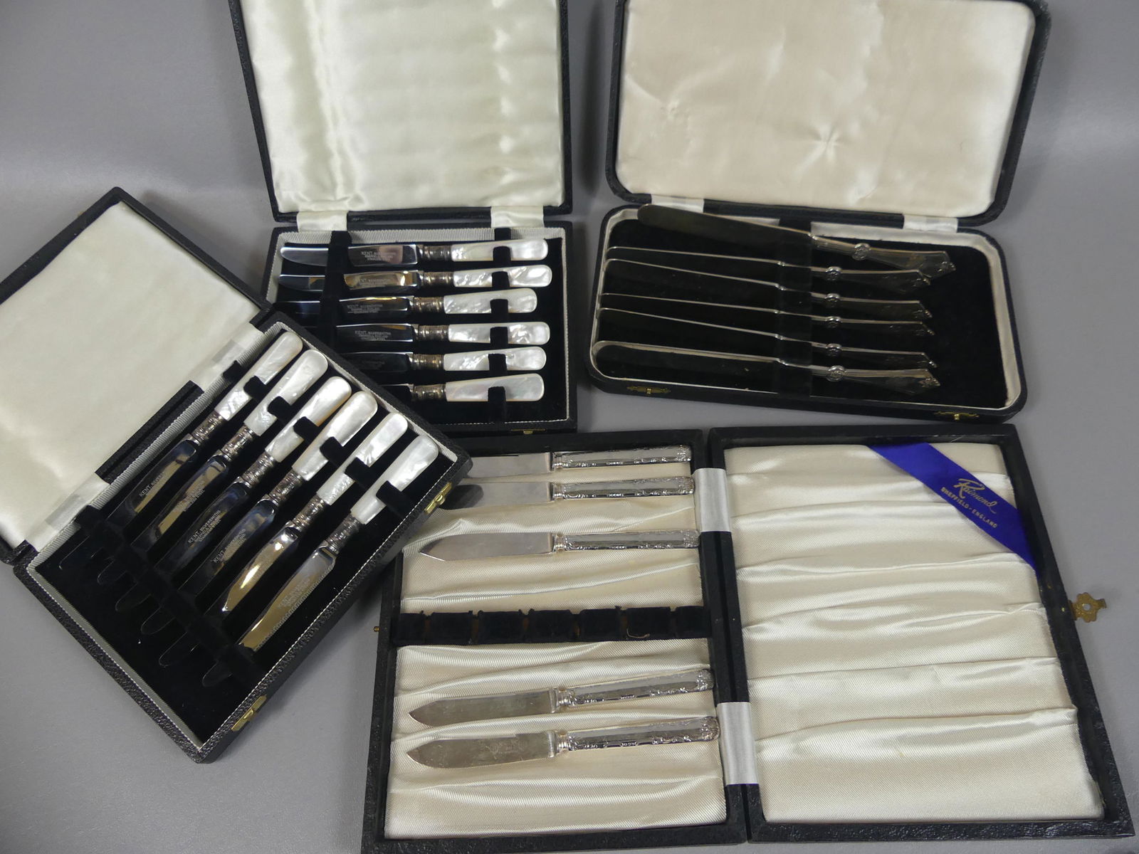 4 SILVER SETS - GORHAM ROSETTE KNIVES: Lot of 4 cased silver flatware sets (boxes may not be original) including heavy sterling silver set of 6 Gorham 8 inch knives in Rosette pattern ca 1868 (10 ozt); plus 2 cased Sheffield fruit knivees