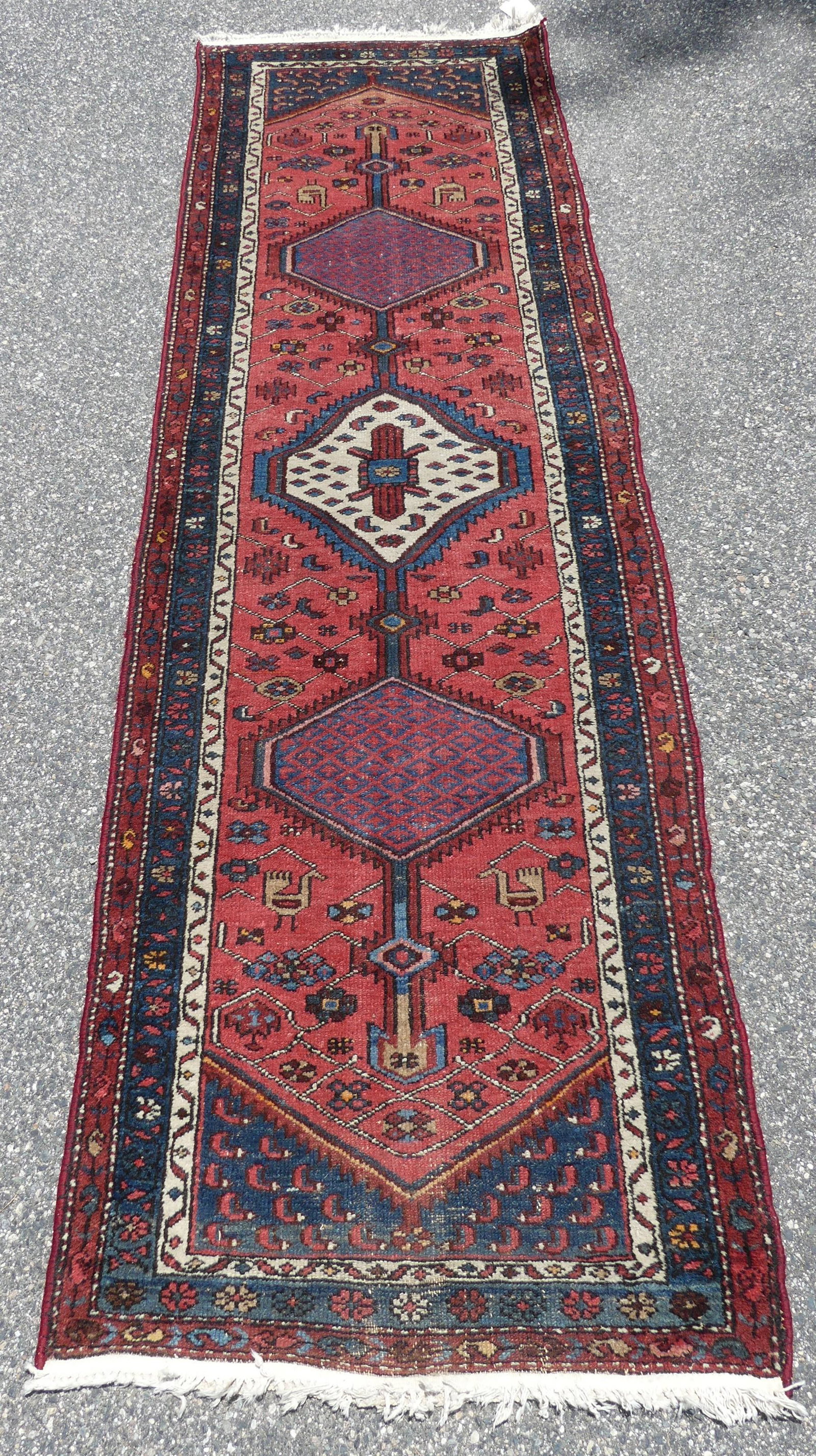 ANTIQUE KARAJA RUNNER: Old Karaja runner with triple medallion in mostly reds and blues. 9 ft 9 inches by 2 ft 10. Good condition.