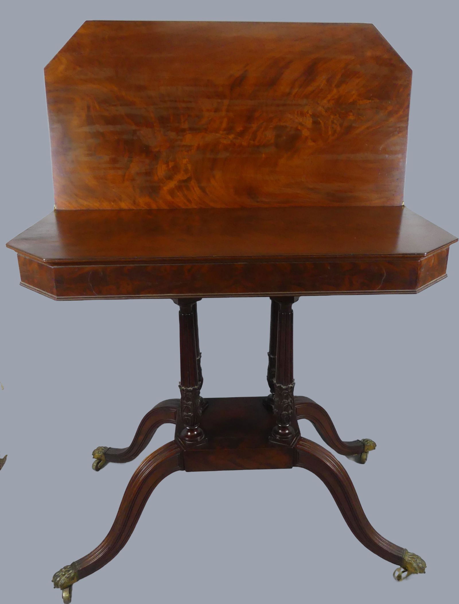 PERIOD DUNCAN PHYFE CARD TABLE: Fine antique Duncan Phyfe mahogany card table with splayed serpentine legs, brass paw feet and acanthus carved columns. 33 in long x 18 d x 29 h. Excellent condition.