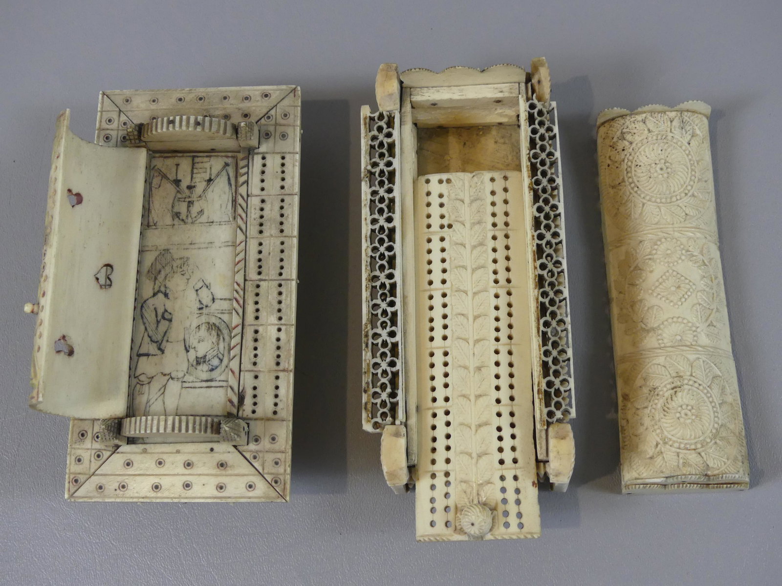 2 POW BONE GAME BOXES: Lot two 19th century prisoner-of-war whale bone game boxes, one with hinged dome lid that reveals a painted scene of sailor and anchor; other has sliding curved lid with cribbage board. Each about 6 x