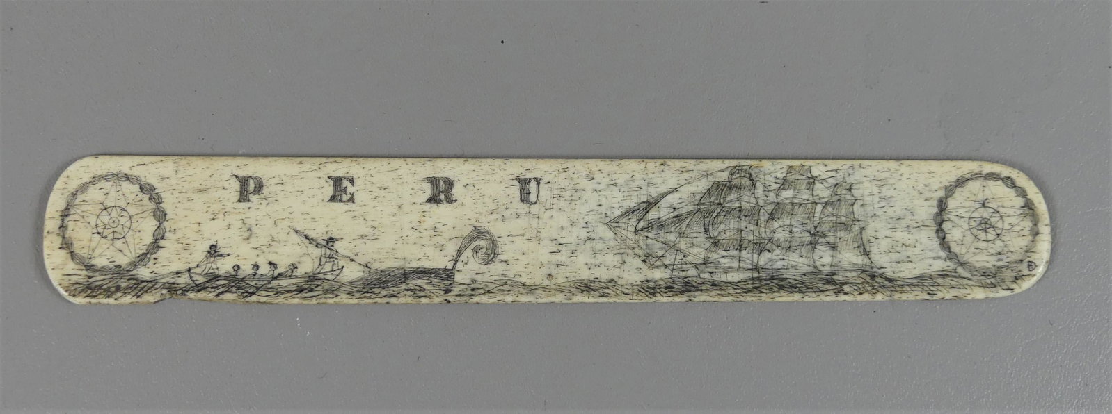 SAILOR MADE PERU SCRIMSHAW BONE BUSK: Antique sailor-made whalebone busk with scrimshaw PERU and whaling scene. 10.5 x 1.5 in wide.