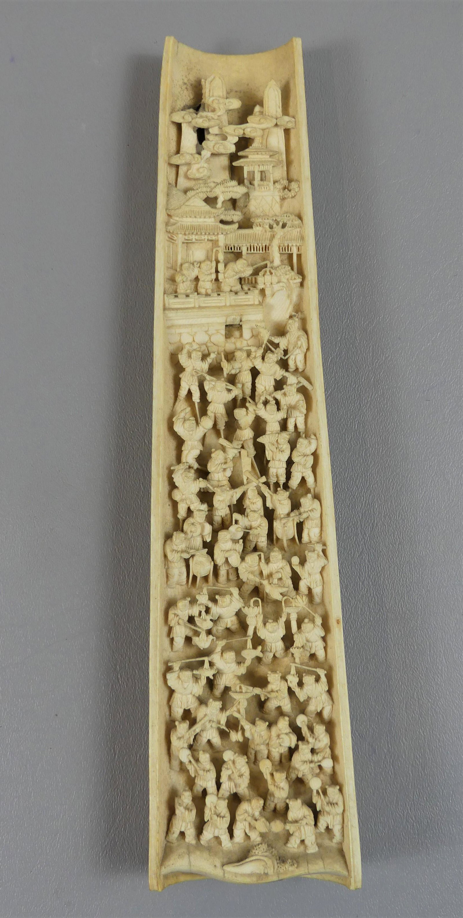 JAPANESE CARVED BONE SCULPTURE: Highly detailed 19th century Japanese Meiji carved bone 1/2 column depicting many Asian figures, temples, etc. Exterior is also relief carved with genre scene. 12 in tall x 2.5 in wide.