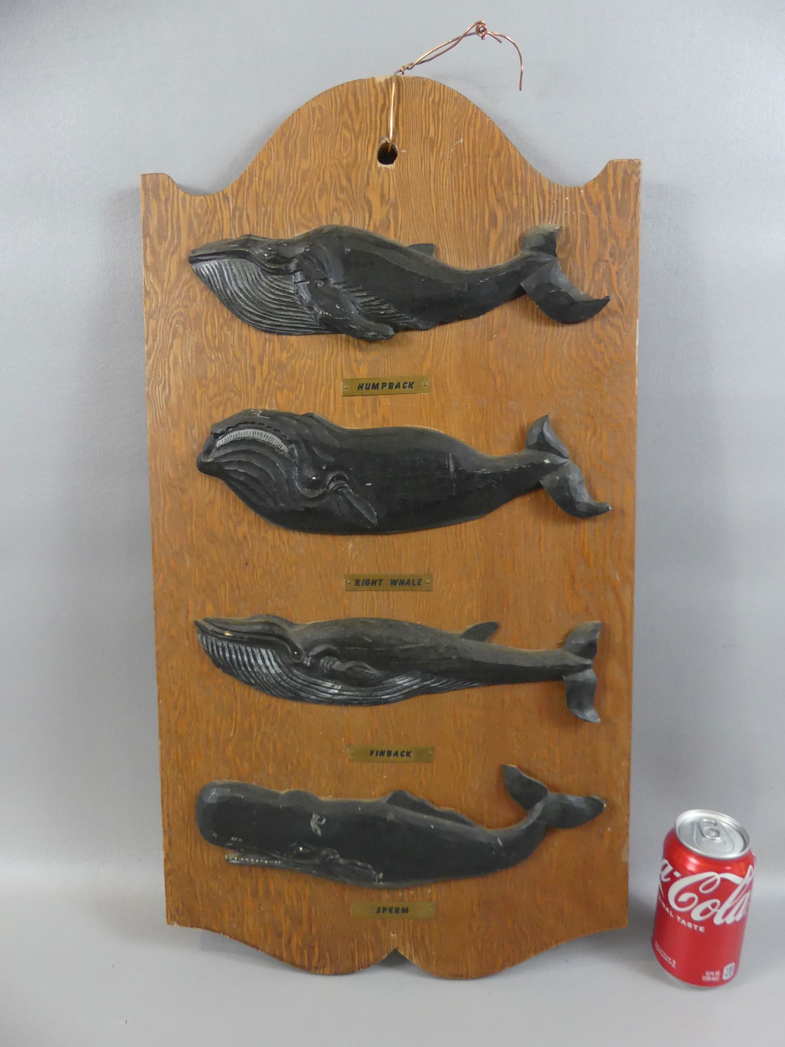 NEW BEDFORD WHALE PLAQUE: Vintage wood plaque with 4 carved wood whales, signed Moby Dick Marine Specialties, New Bedford. 26 x 14 inches.