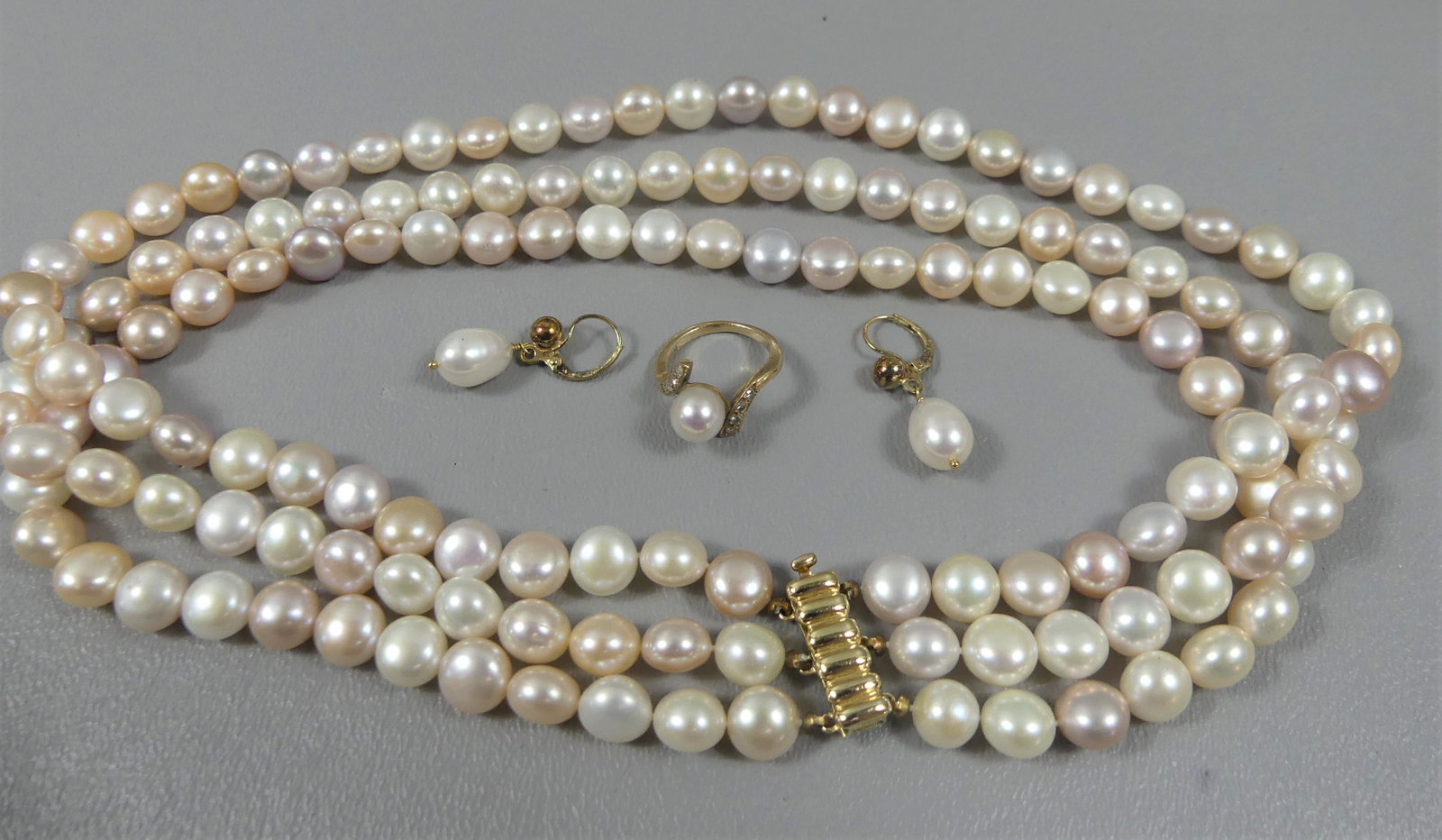 GOLD & PEARL JEWELRY GROUP: Lot of 4 pieces of 14k gold and pearl jewelry: triple strand pearl choker, 15.5 in, gold clasp; pair of earrings; and size 3.5 yellow gold and pearl ladies ring.