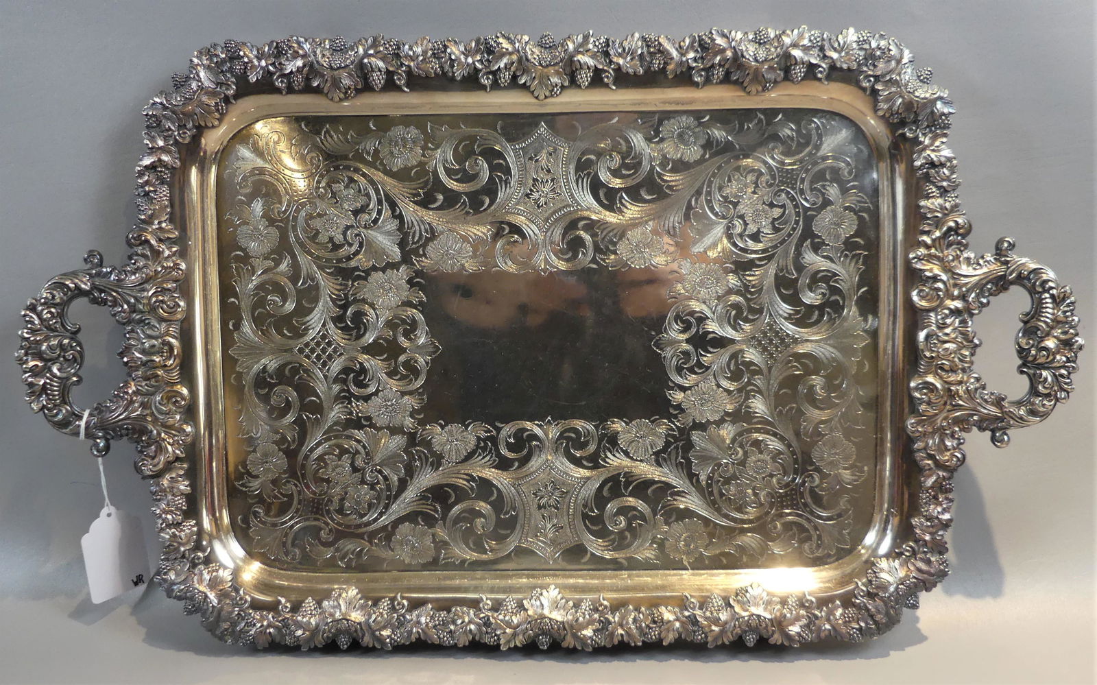 ROCOCO SILVER PLATED TRAY: Heavy, rococo antique silver plated rectangular serving tray with embossed grapes and leaves and engraved designs, unsigned. 28 x 17 in, surface area 18.5 x 13 in.