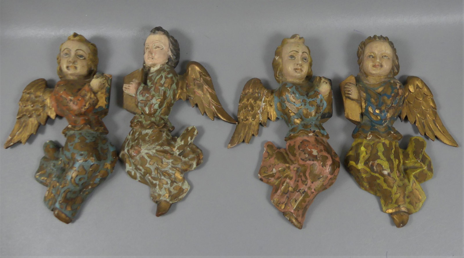 SET 4 CARVED WOOD ANGELS: Set 4 antique carved wood and polychromed angel wall sculptures. 11 in high. Good with some minor repairs.