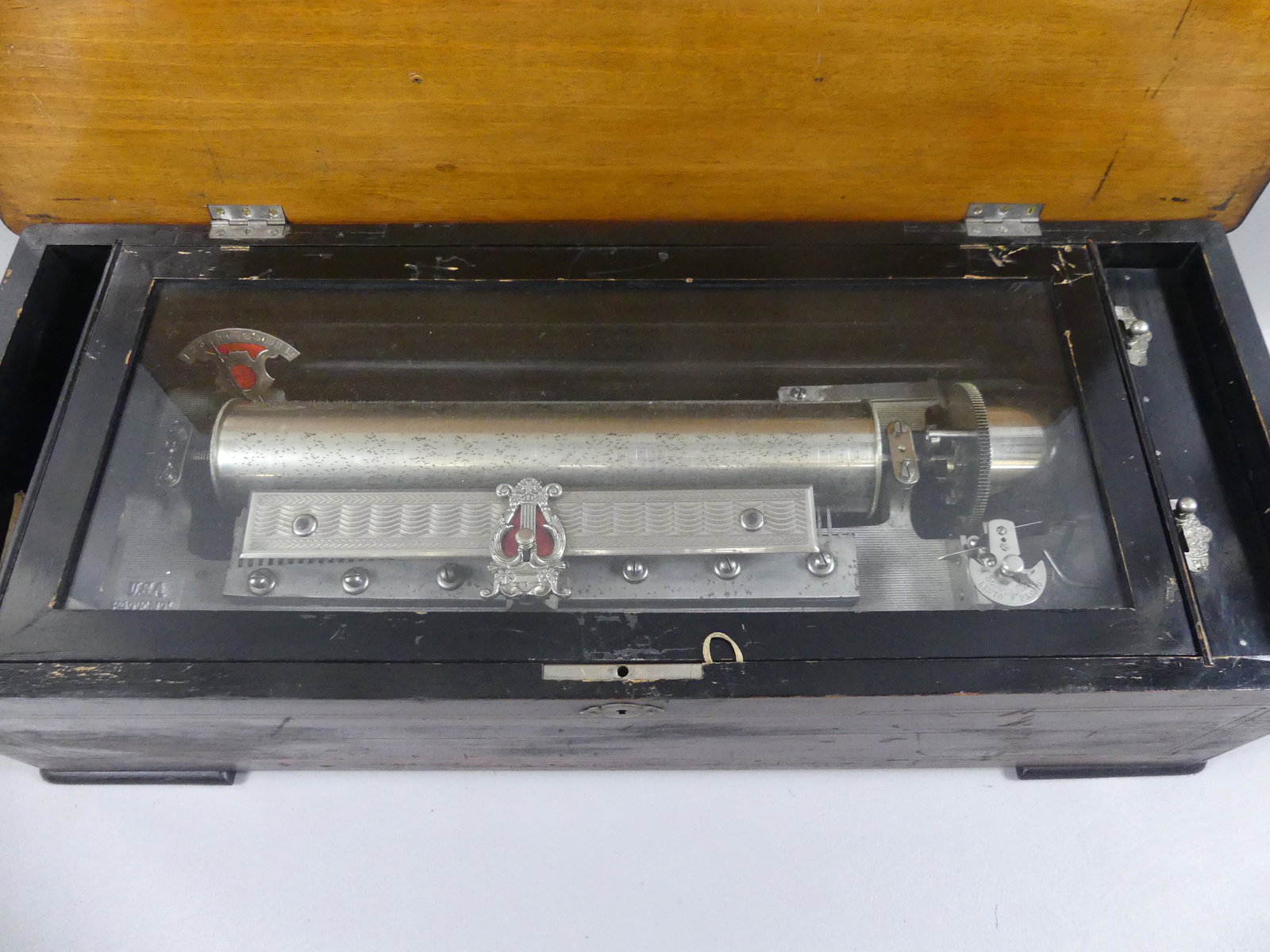 ANTIQUE SWISS CYLINDER MUSIC BOX: Large antique Swiss music box with inlaid walnut case, 13.5 in long cylinder, 12 tunes (hand written card), patent 1894, no maker name. 26 in long x 10.5 x 7 high. Working condition, 2 teeth missing o
