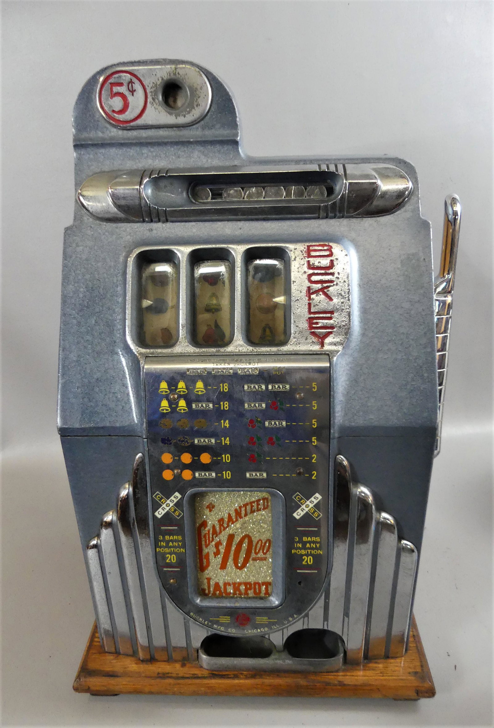 BUCKLEY CHICAGO 5C SLOT MACHINE: Circa 1920's 5 cent slot machine by Buckley Mfg. Co of Chicago with oak and metal case. 27 high x 16 x 15 in. Wheels are not spinning so may need overhaul or cleaning.