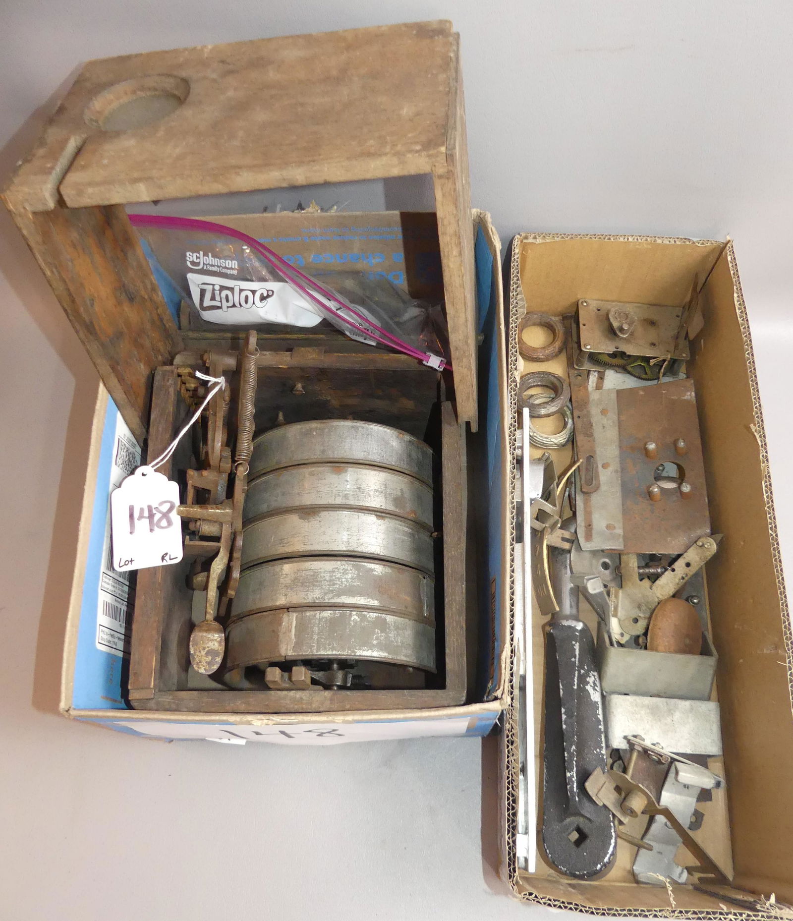 ANTIQUE SLOT MACHINE PARTS: 2 boxes of antique slot machine parts including oak case pieces, 7 in wide reels, etc. As found. Also 2 bells, plates, fittings, handle, 13.5 in GUM plate; etc.