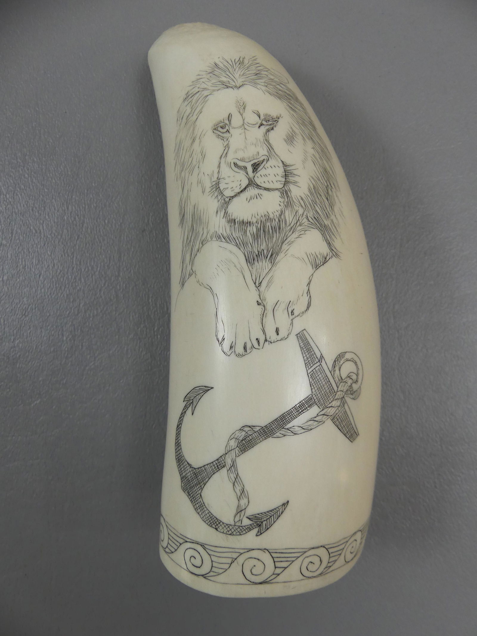 SCRIMSHAW WHALE TOOTH SHIP LION: Large whale tooth with scrimshaw of ship LION and having a lion and anchor verso. 6 x 2 in, weighs 15.98 oz