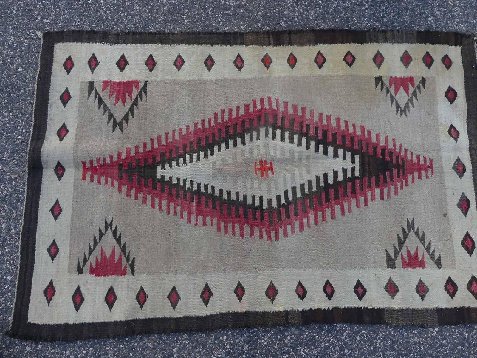 ANTIQUE NAVAJO RUG: Antique Navajo Native American rug in with central diamond design in red and brown colors, etc. 3 ft 3 by 5 ft 3 in.
