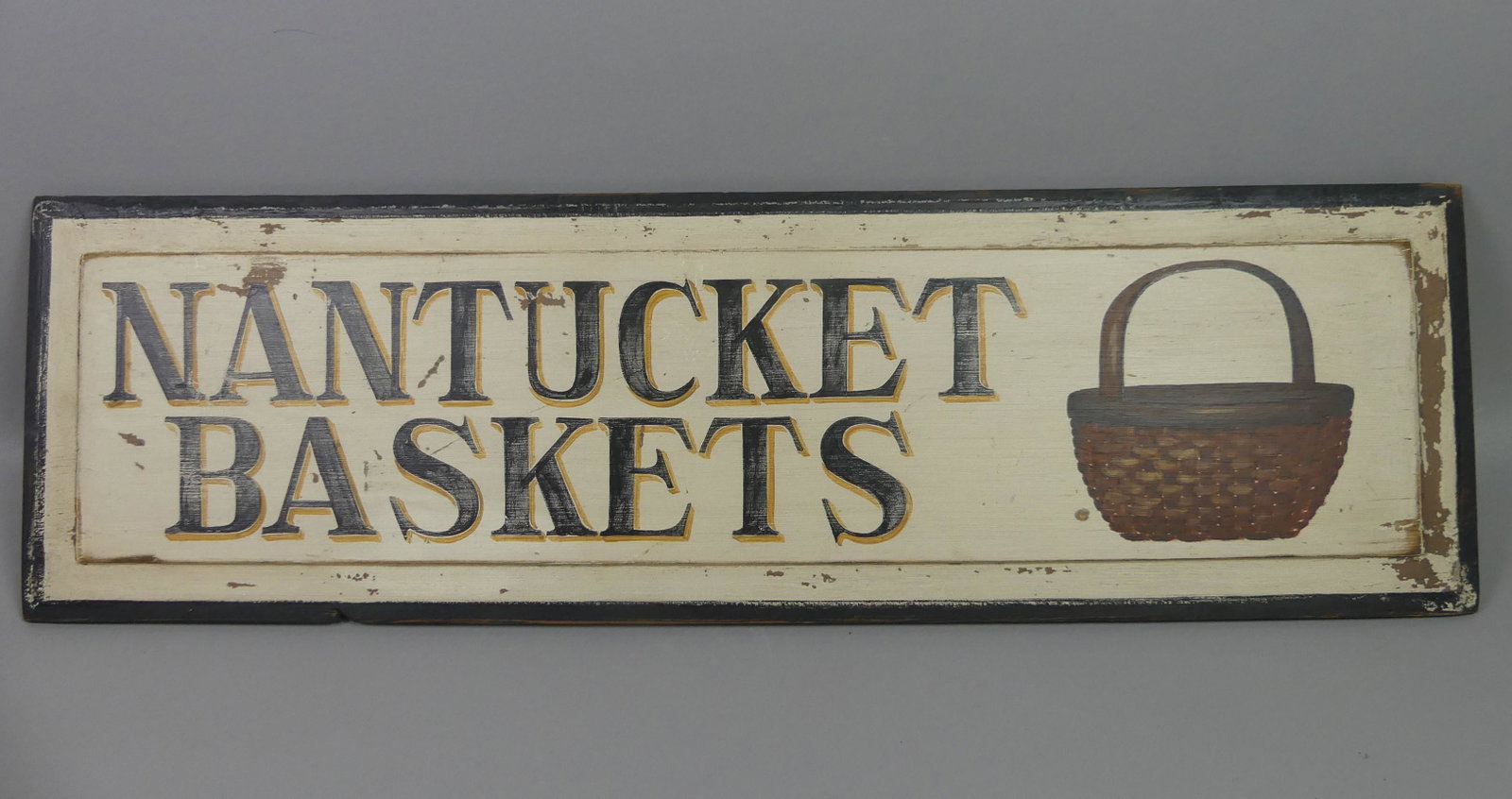 NANTUCKET BASKETS SIGN: Painted wood NANTUCKET BASKETS sign. 10.5 x 35.5 in long.