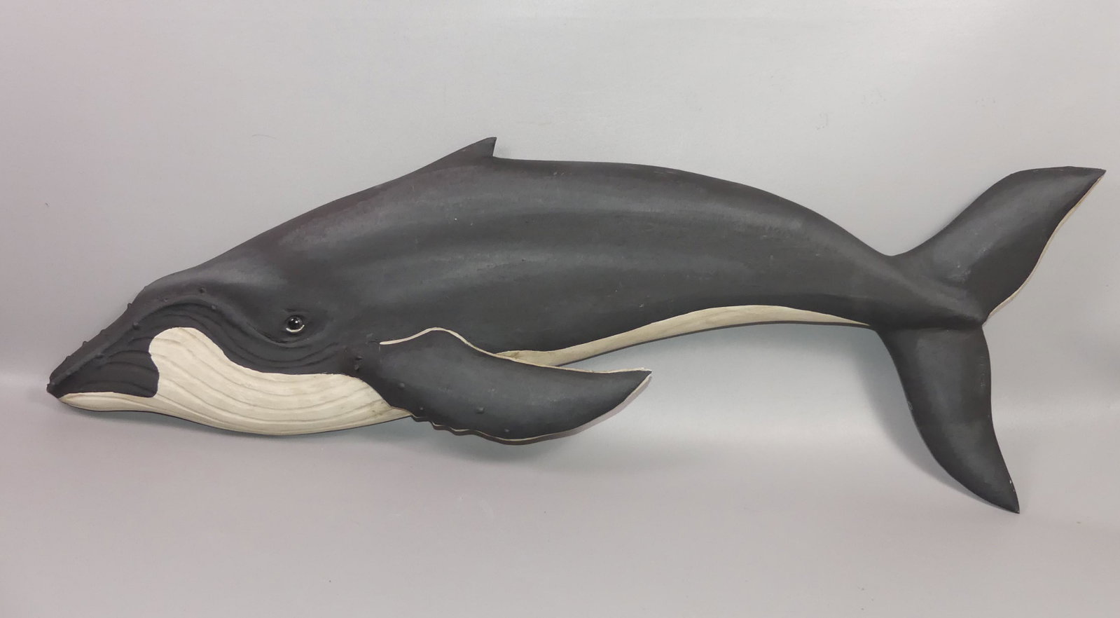 K. BECKENHAUPT HUMPBACK WHALE PLAQUE: Carved and painted wood humpback whale plaque signed Ken Beckenhaupt, Cape Cod. 40 in long by 14 high.