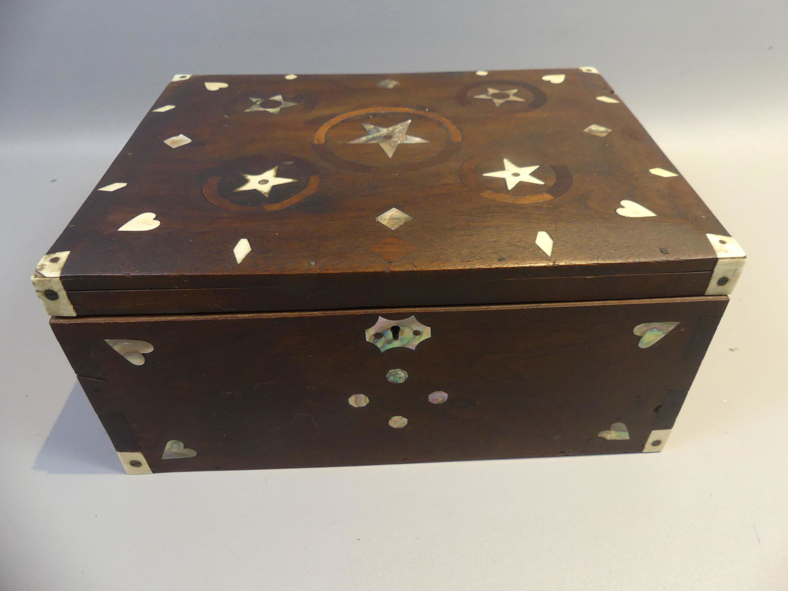 ANTIQUE SAILOR MADE INLAID BOX: Fine 19th century sailor made mahogany dovetailed box with inlaid abalone and whale bone. Has hearts, stars, diamonds, etc. 10.5 x 4.5 x 5 inches.