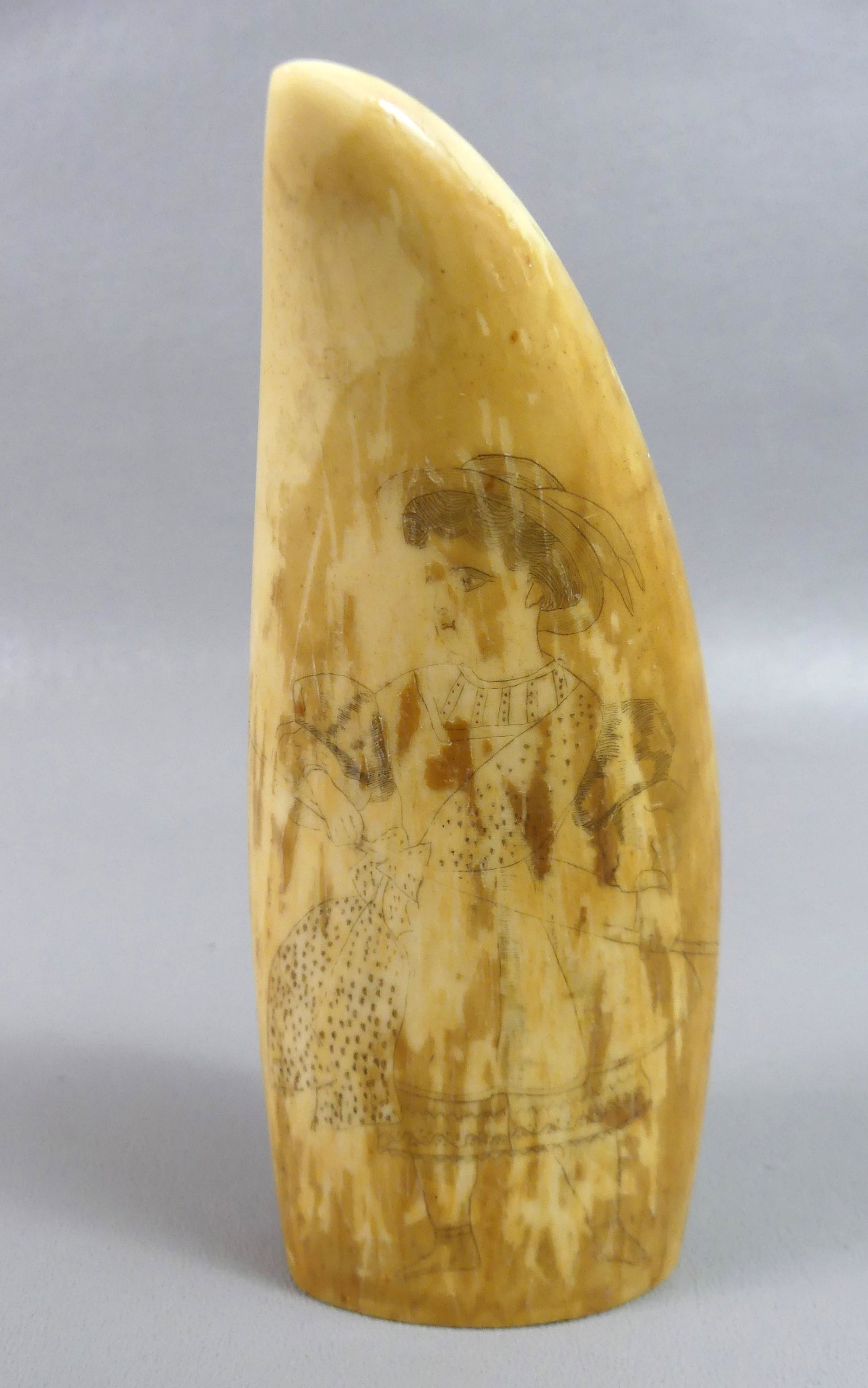 WHALE TOOTH - PEASANT HOLDING RAKE: Antique whale tooth with scrimshaw of a young peasant woman holding a hay rake (discolored). 5.25 in by 2.12, weighs 12.5 oz.