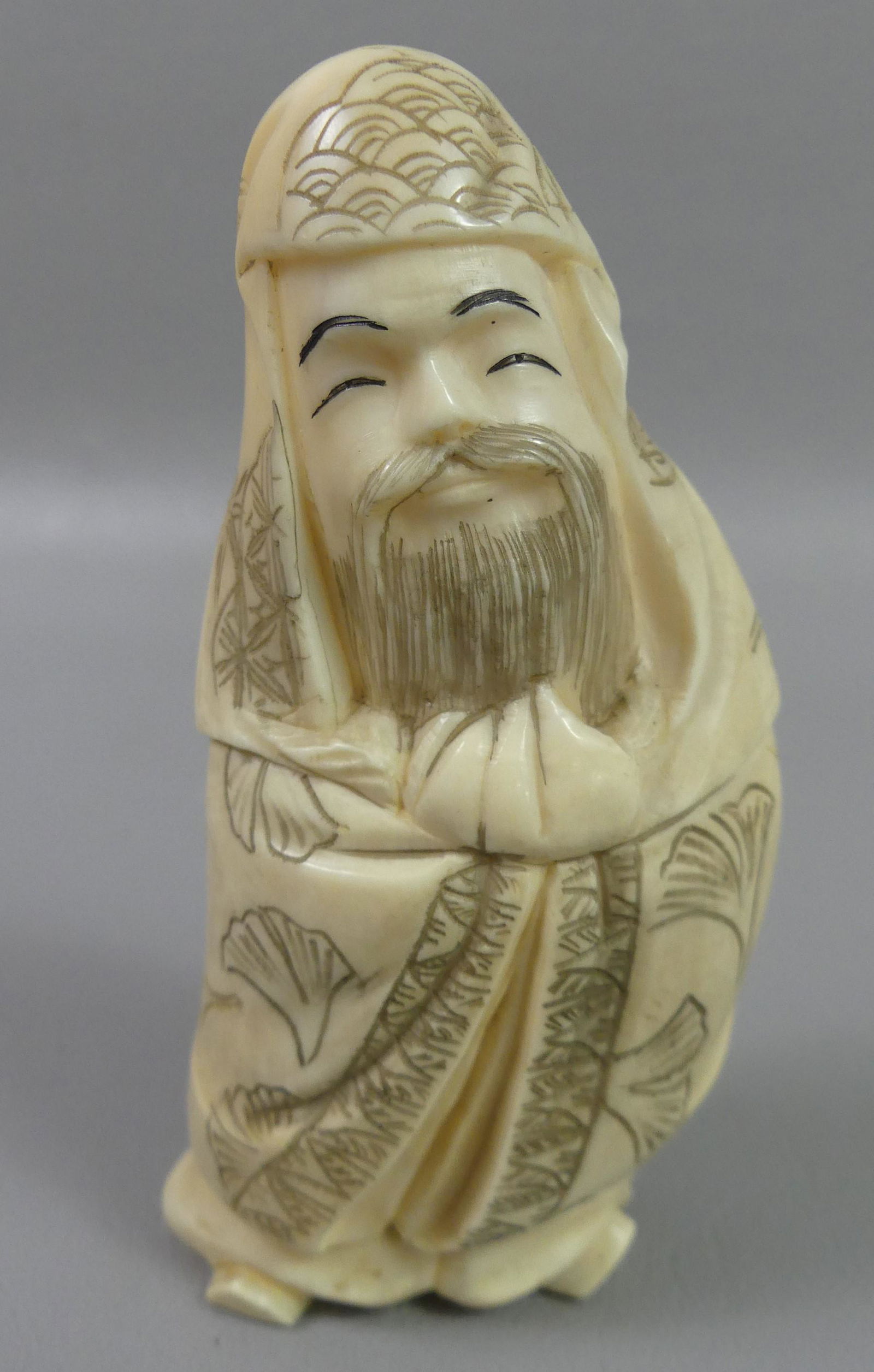ANTIQUE WHALE TOOTH OF ASIAN MAN: Antique Asian carved whale tooth in form of a bearded man in robe, 4 in tall, 5.4 oz.