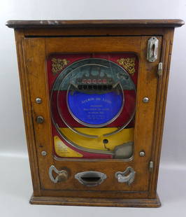 ALLWIN COUNTERTOP SLOT MACHINE: Circa 1920 Allwin deluxe penny slot machine in oak case. 27.5 in tall x 19 x 7.5 in. Missing glass, not working, no key. Weighs 39 lbs.