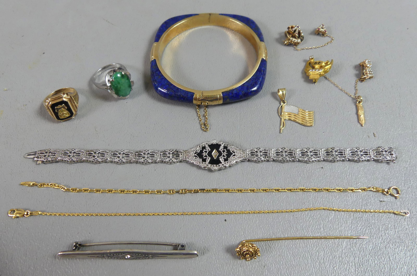 LOT 14K GOLD JEWELRY: Lot gold jewelry including: Art Deco white filigree gold bracelet with onyx, size 6.5; 2 rings; 2 thin chain bracelets, 6.5 in; heavy lapis and 14k gold cuff bracelet; bar and stick pin; and 2 fratern