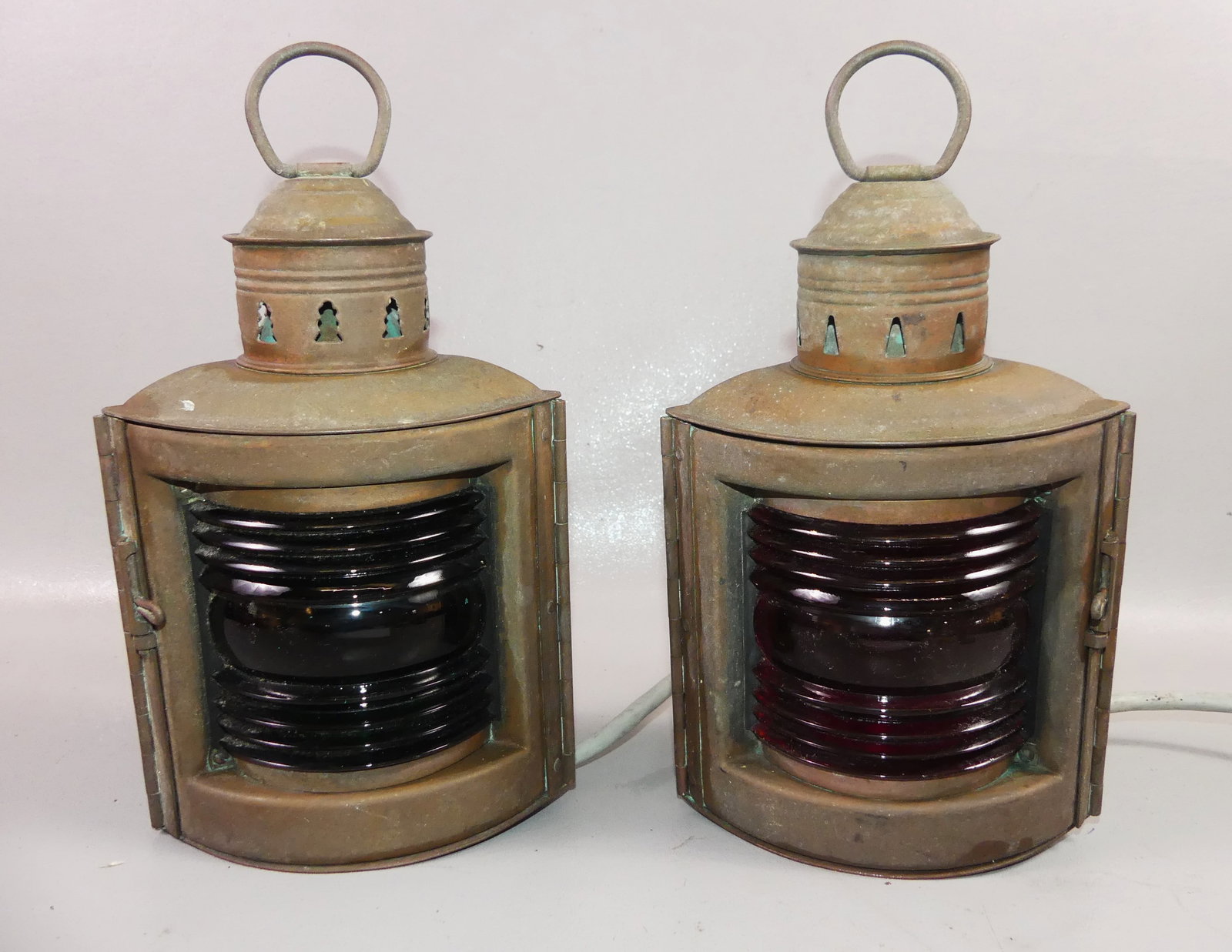 PAIR WILCOX SHIP LANTERNS: Pair of nautical copper port & starboard lamps signed Wilcox, Crittendon & Co of Conn. with red and green glass lenses. Electrified, 11.5 in to top of handle, 6 in wide.