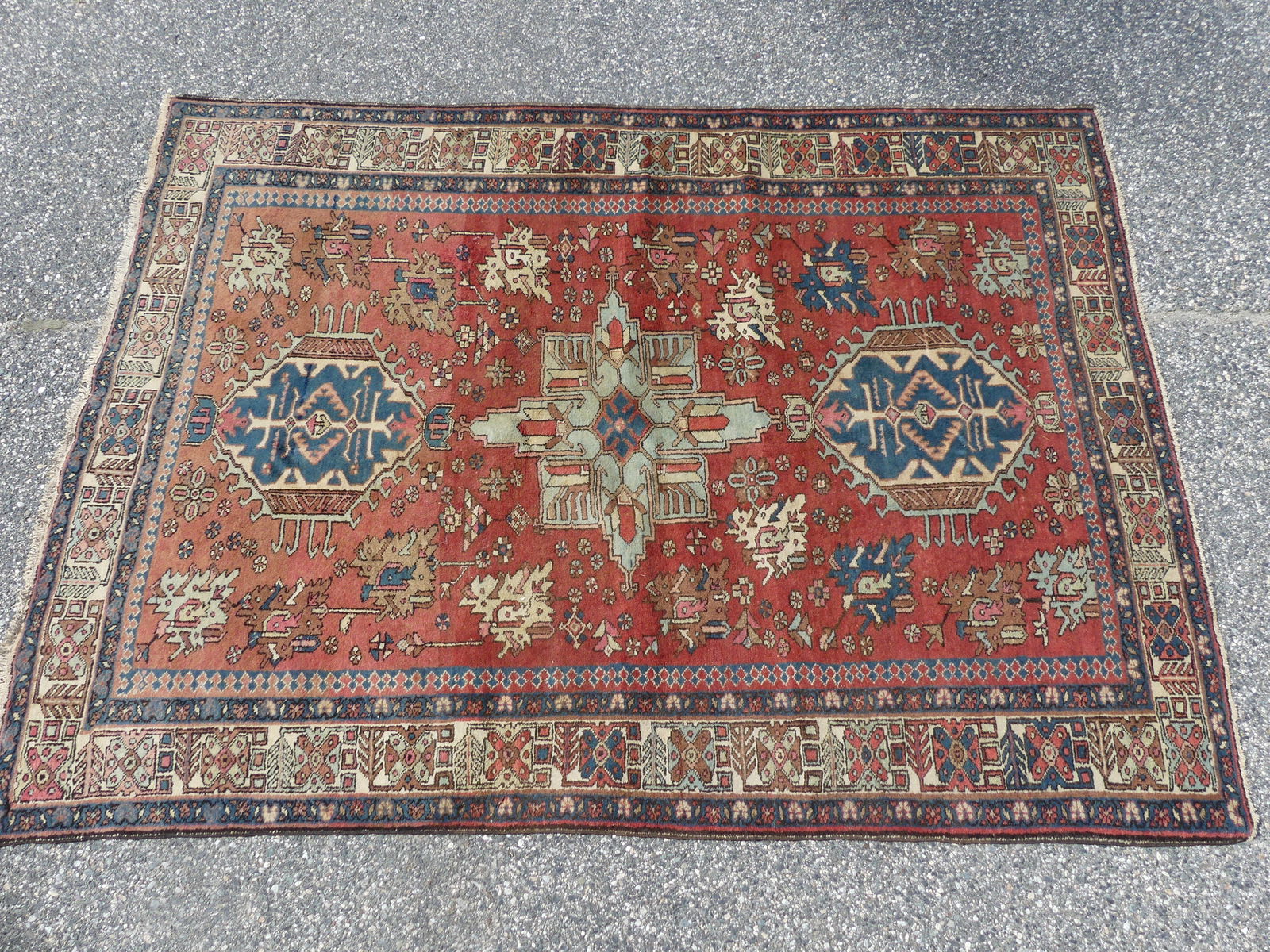 ANTIQUE KARABAUGH RUG: Antique Karabaugh scatter rust with pale rust and blue colors, geometric designs. 4 ft 8 by 6 ft 4 inches. Good condition, could use a cleaning.