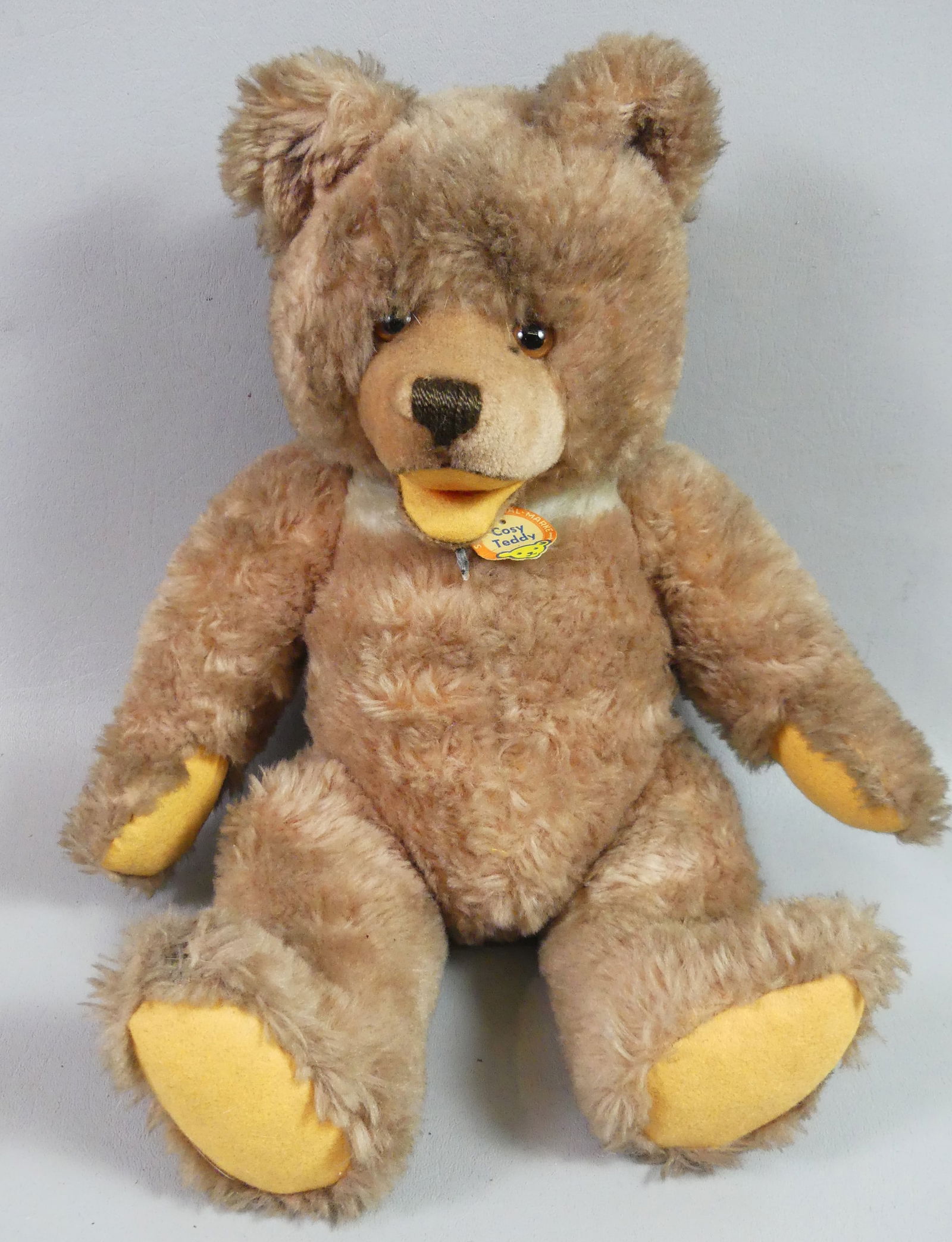 OLD STEIFF COSY TEDDY BEAR: Old Steiff stuffed teddy bear named COSY, with 2 original paper tags but missing ear tag. Size: 16 in.