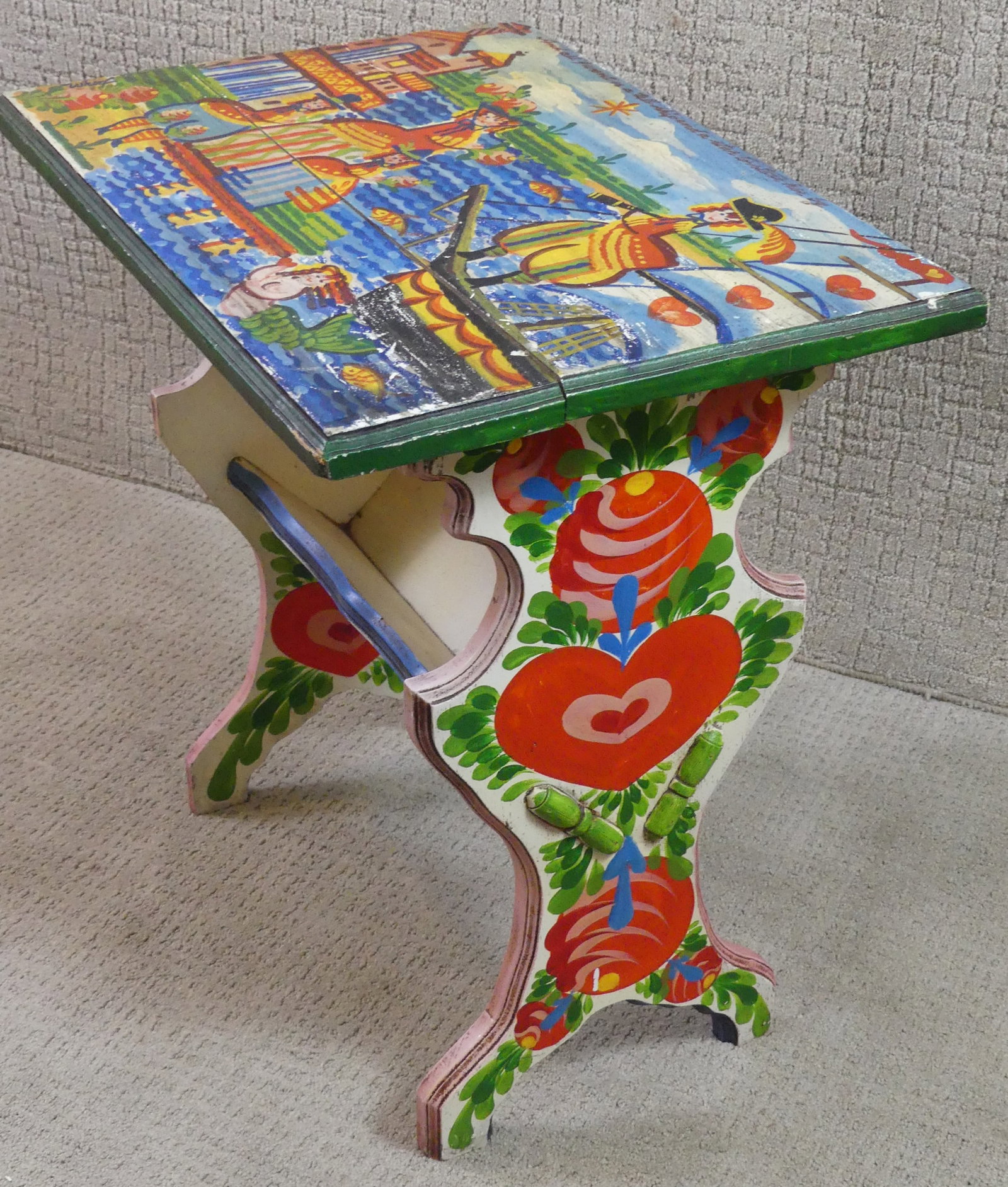 NANCY WHORF DECORATED BOOK TROUGH: Old wood book trough table with paint decoration by Nancy Whorf. Top painted with a ship, pirate, and family with notation - All I want is a tall ship and a star to steer her by. Signed Whorf. 24.5 x