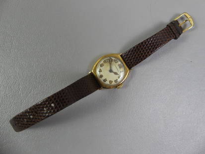 TIFFANY MENS WRISTWATCH: Old Tiffany & Co. 14k gold men's watch, 1" square dial (25.4mm), brown leather strap. Discolored dial, monogram and date of 1913 on back. Weighs 19.4 dwt