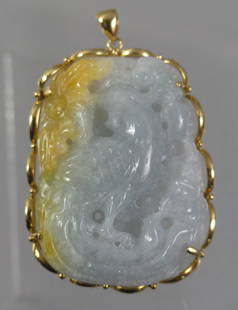 GOLD MOUNTED JADE BROOCH: 2 color jade pendant with carved pheasant and 14k gold frame. 2.25 x 1.5 in, weighs 50.8 grams or 32.66 dwt