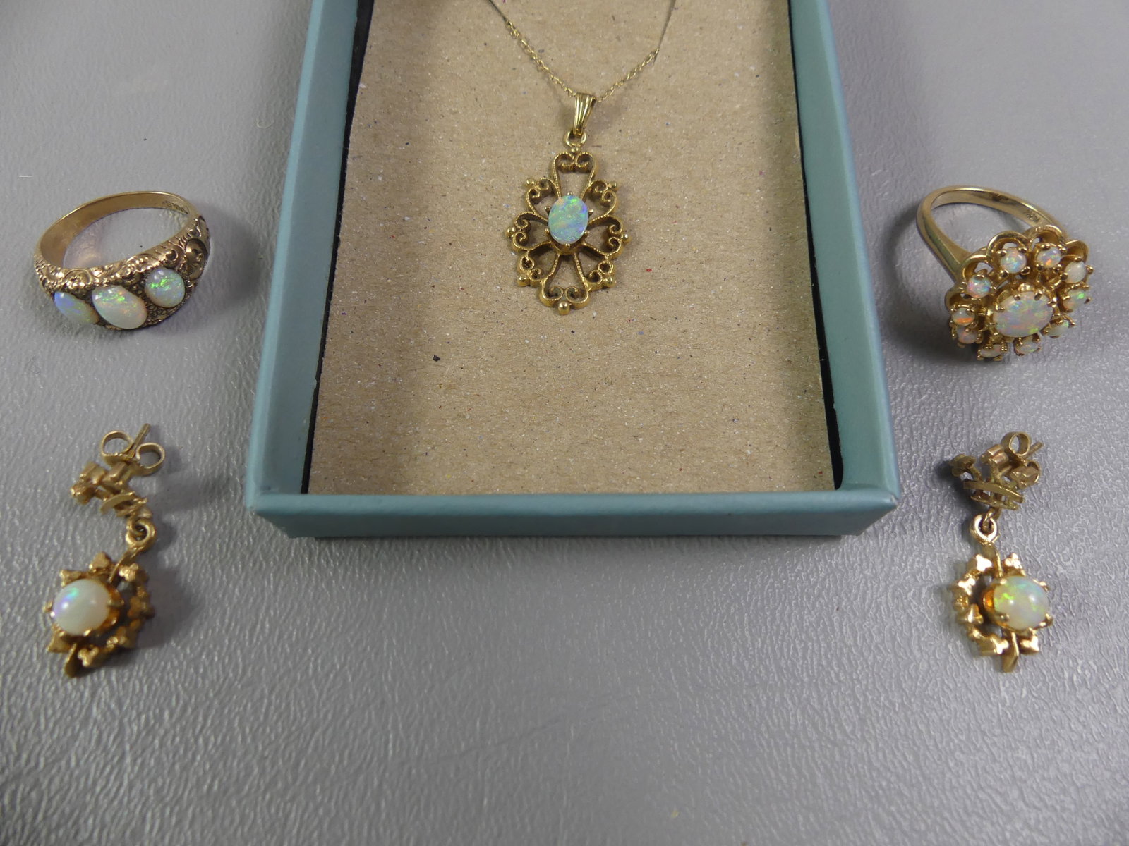 14K GOLD & OPALS JEWELRY LOT: 14k gold mounted jewelry with opal stones - necklace, 2 rings, pair of earrings. Three stone ring is 10k and size 5; other multi-stone ring is 14k and size 6.5. Total 13.2 dwt.