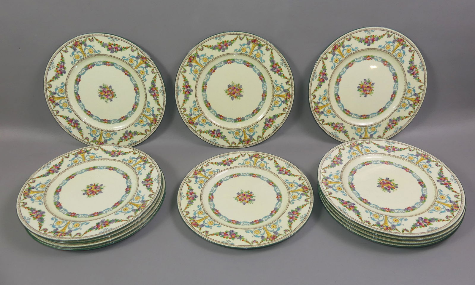 12 WEDGWOOD DINNER PLATES: Set of 12 colorful enamel dinner plates with fruit and flowers in the Ventnor pattern W962. 10.5 in diameter. All perfect condition, may have some scattered light utensil marks.