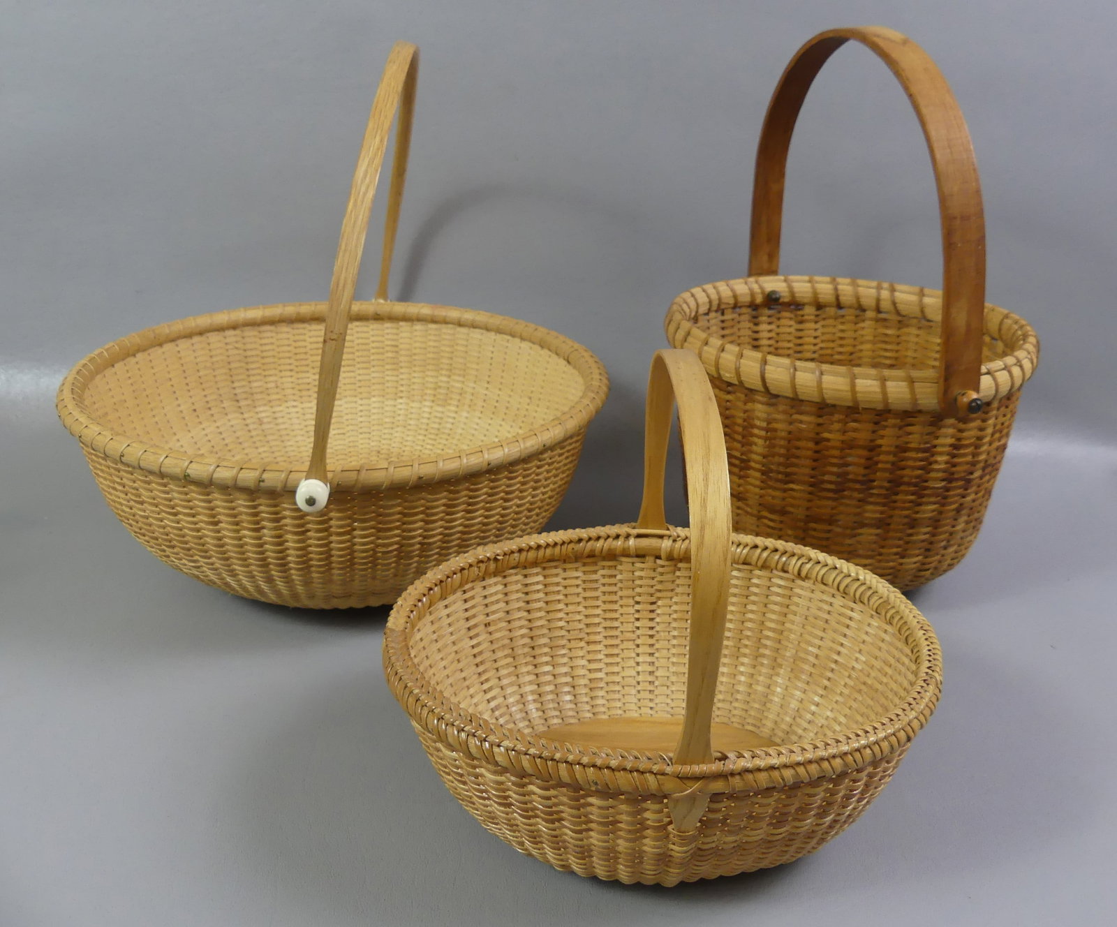 3 NANTUCKET BASKETS: Lot of 3 baskets: Nantucket 7 in signed Don Craven, Orange St 1978; 2007 Nantucket type signed George Reinhart, Duxbury MA, 10.5 in; and oval basket signed B in circle, 7.5 in.