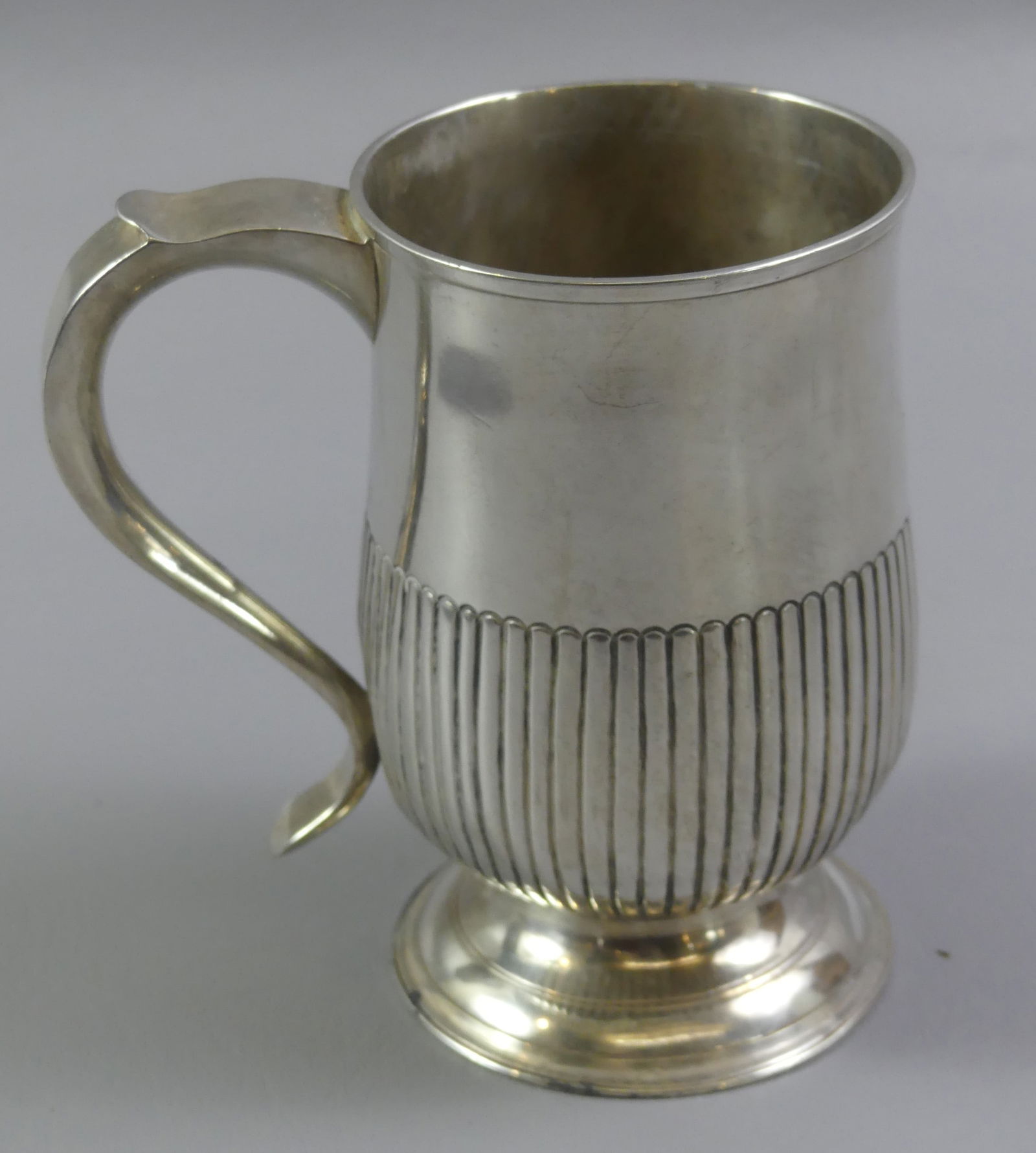 GEORGE III STERLING SILVER CUP: George III English sterling silver footed cup with vertical pickets on lower half of body, hallmarks for London 1799-1800, maker SH or SB (possibly Solomon Hougham). 5.25 in high,, weighs 9.75 ozt. Co