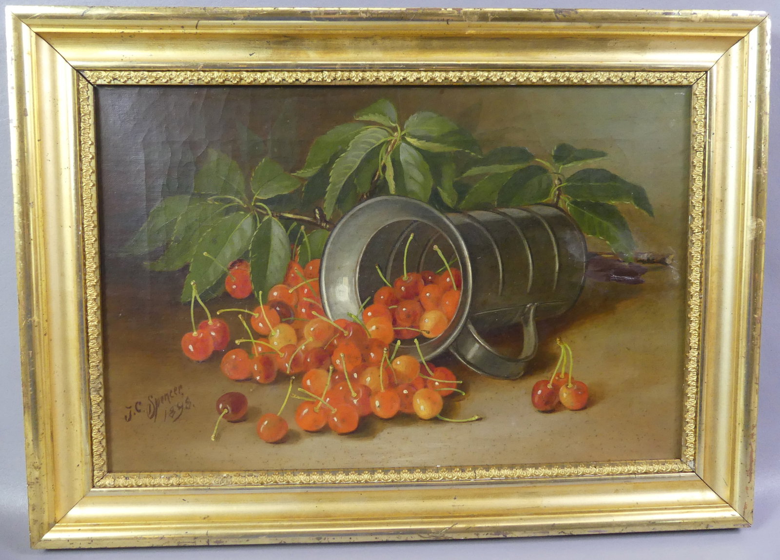 JC SPENCER STILL LIFE PAINTING: Antique oil on canvas still life painting of cherries and pewter measure on tabletop signed JC Spencer 1898. 12 x 18 in, framed 15 x 21 in. Has some touch-up to right middle margin area. (JC Spencer 1