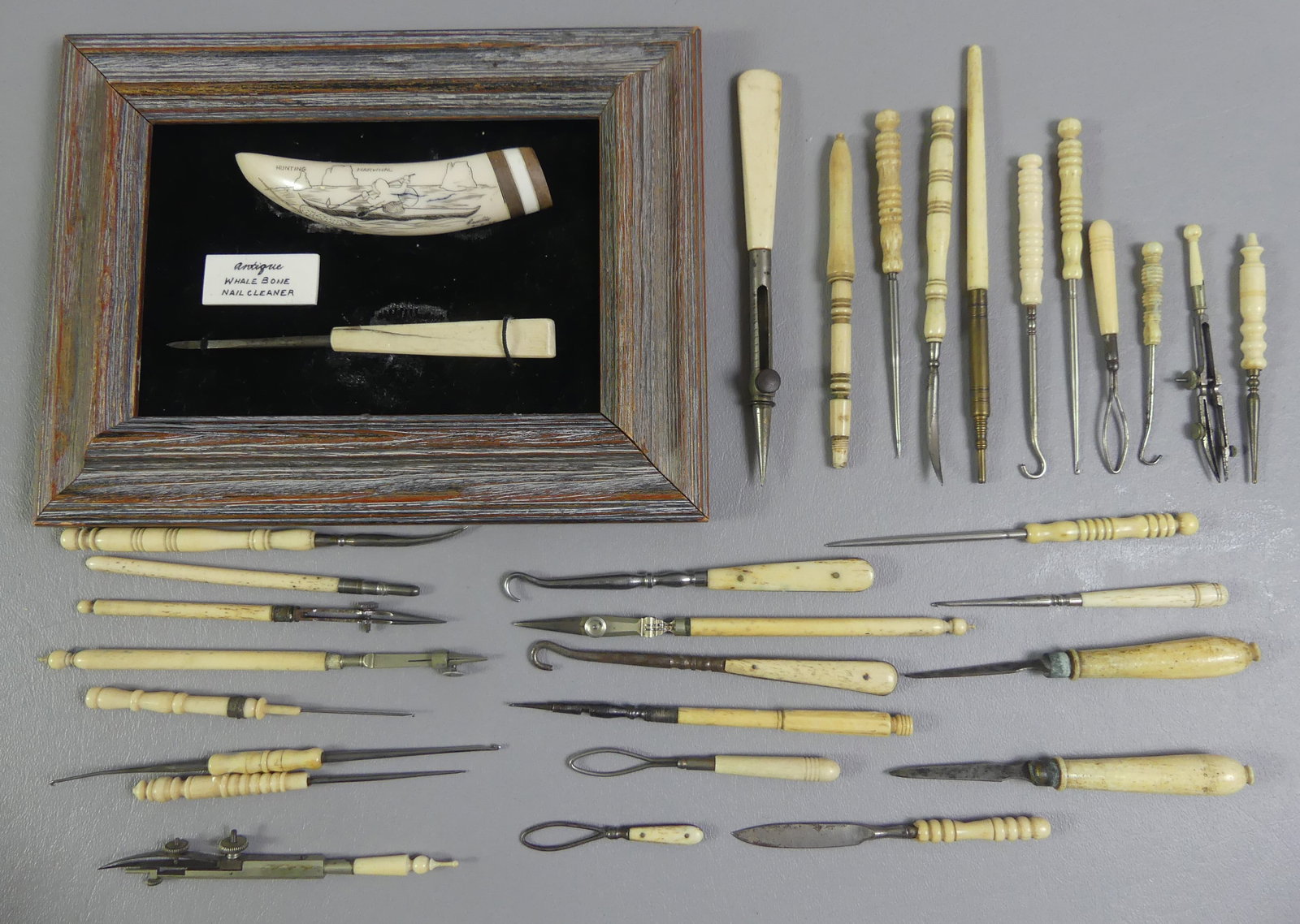 ASSORTED WHALE BONE LOT: Lot of assorted whale bone items: small 4.75 in tooth with scrimshaw Narwhal Hunting signed K. Hamlin 1976 (framed) with whale bone nail cleaner; various implements, button hooks, etc to 6 in long. Ab